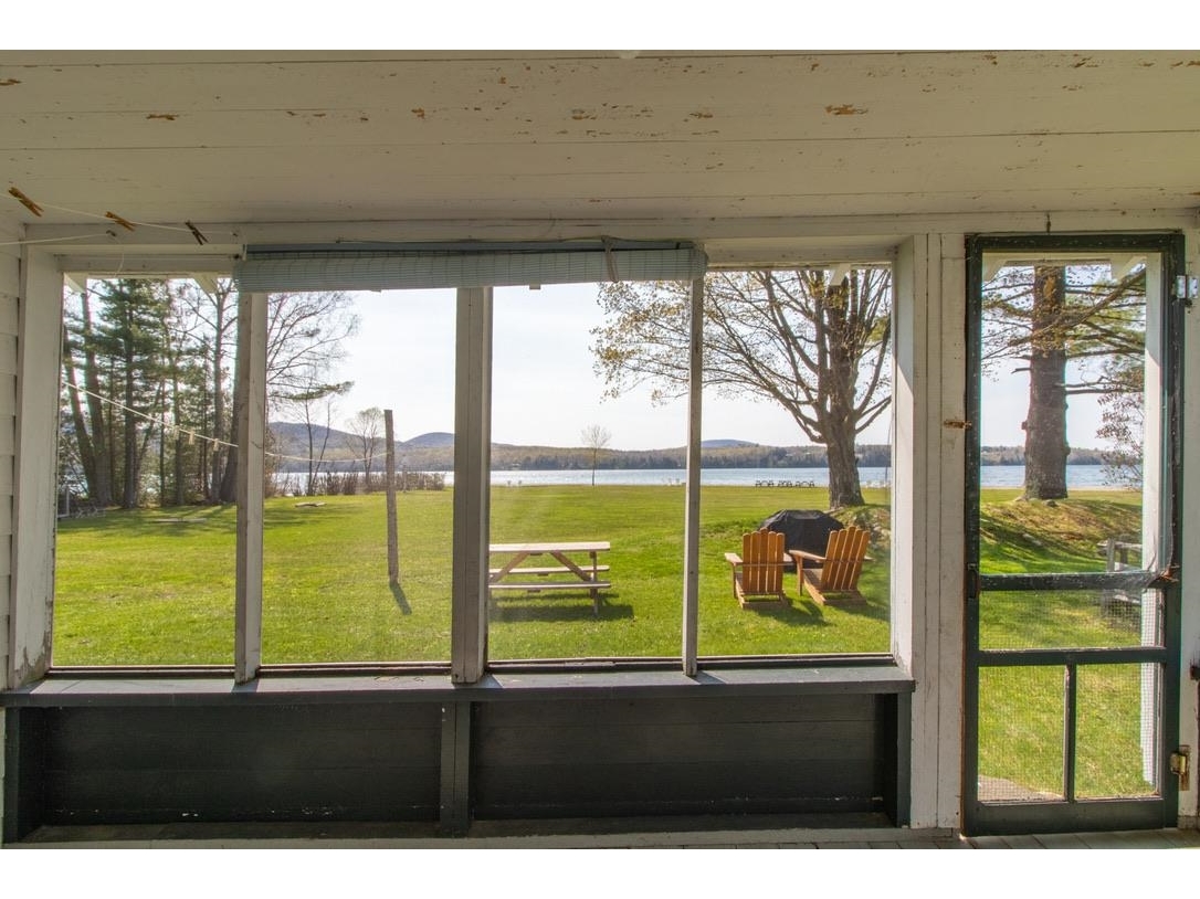 The view of lawn and lake from screened porches on cabins 4-7