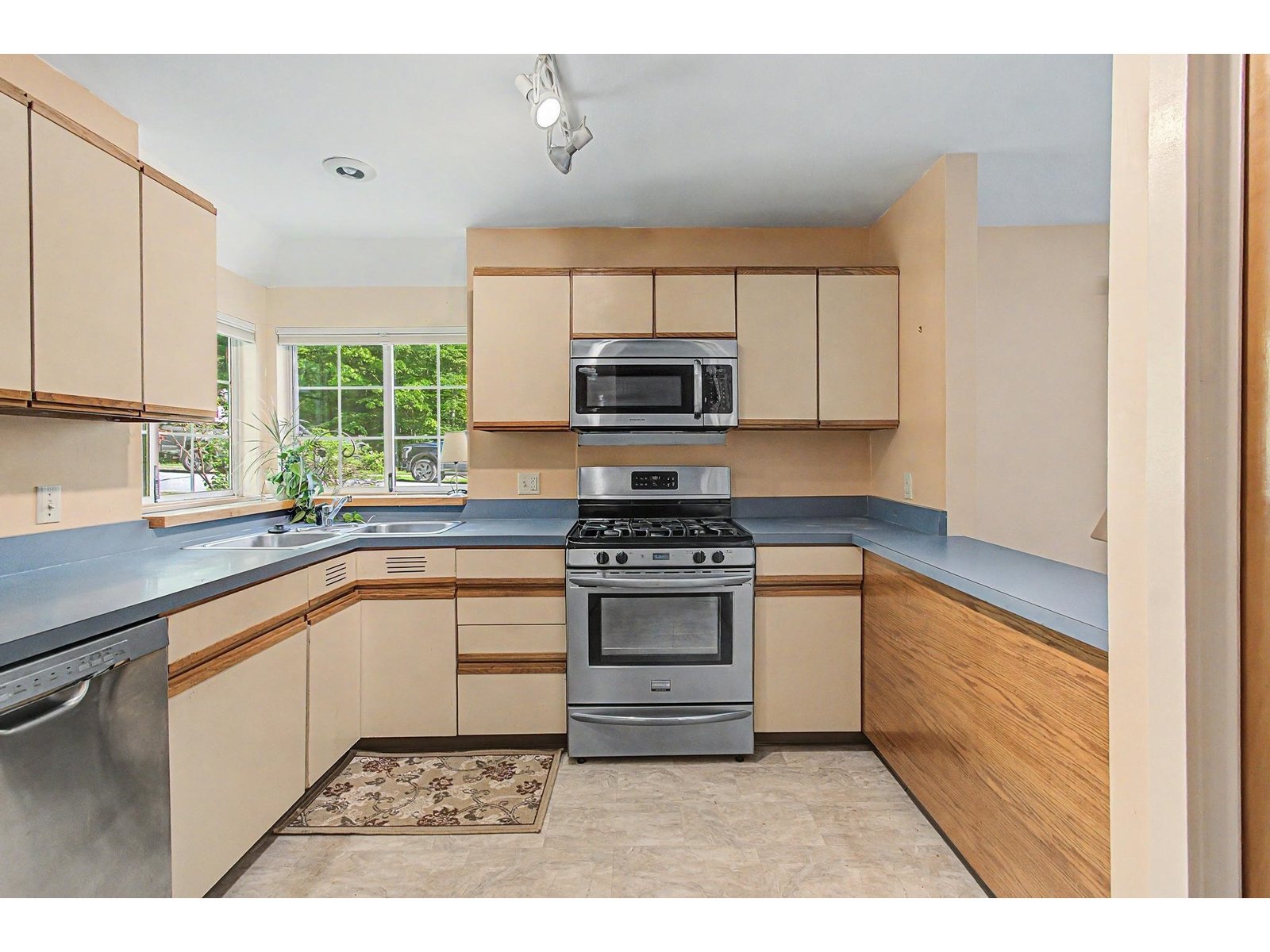 Plenty of cabinetry and a stainless stove and dishwasher.