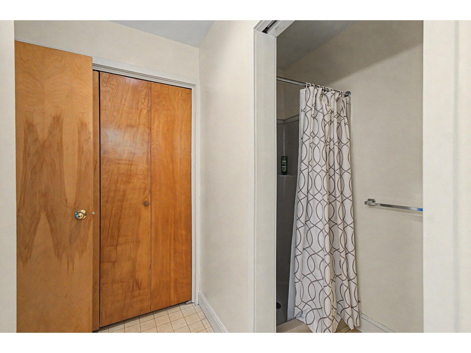 Bathroom closet with laundry and walk in shower.