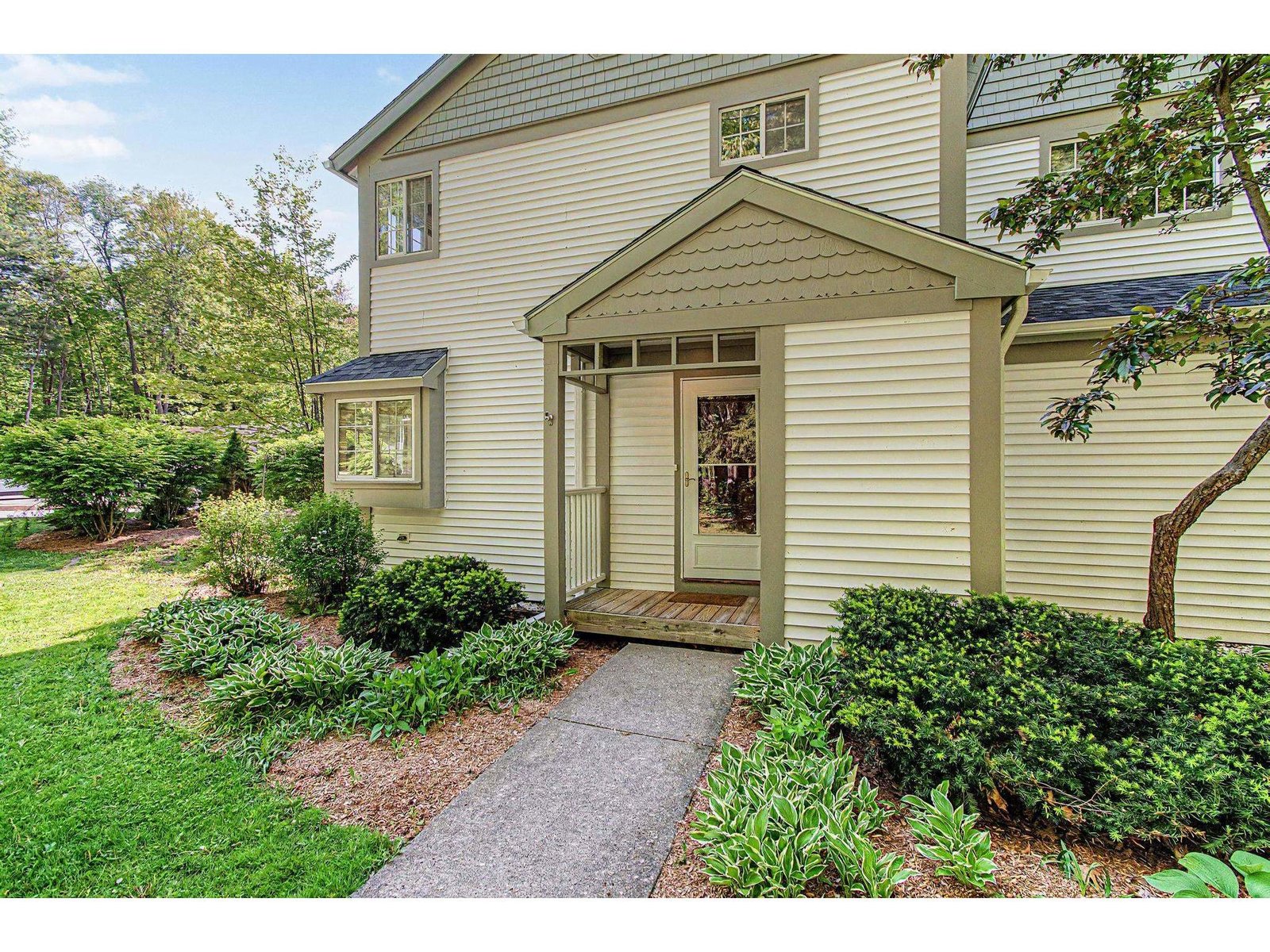 Inviting covered entry with storage closet to the right.