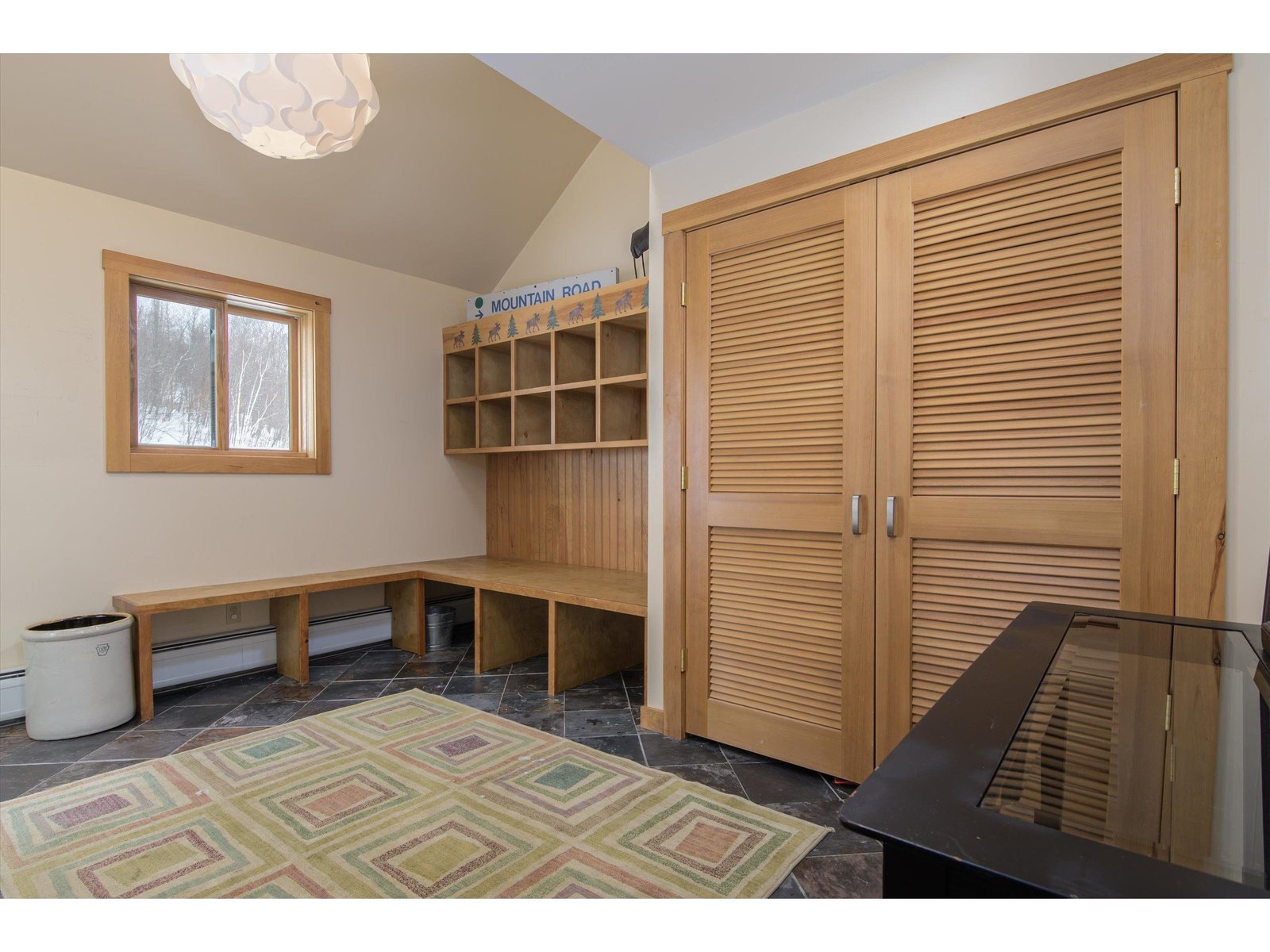 Expanded mud room with  built in cubbies and bench