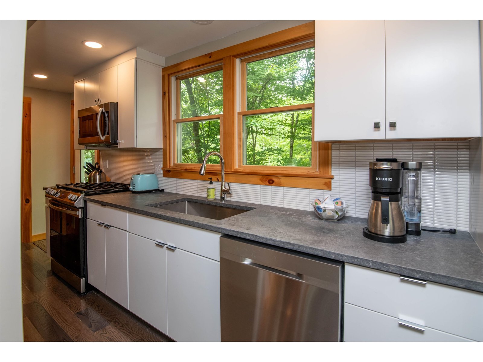 Updated cabinetry, lighting, floors, hardware, fixtures