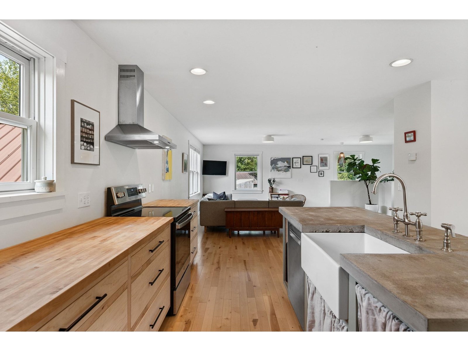 Island with concrete countertop and inlaid ceramic sink