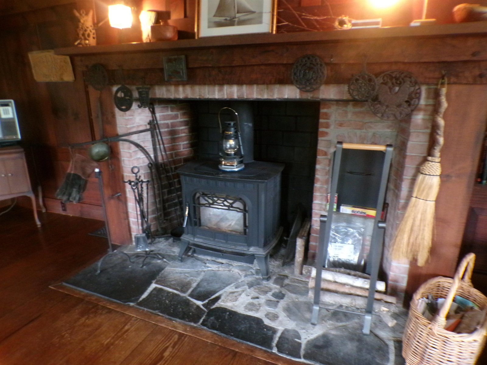 Large colonial style fireplace with woodstove