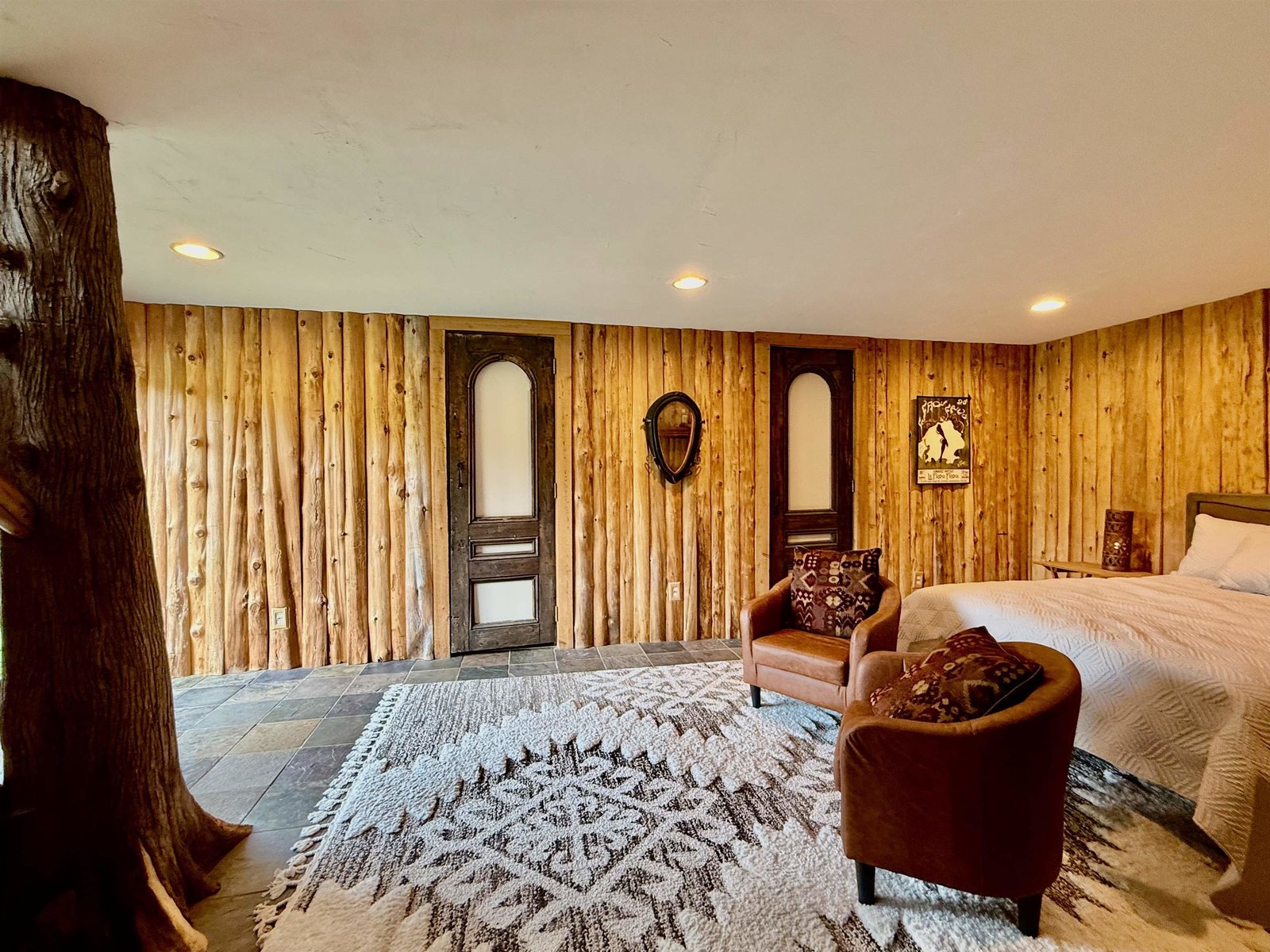 Log accented walls, spacious bathroom with steam shower