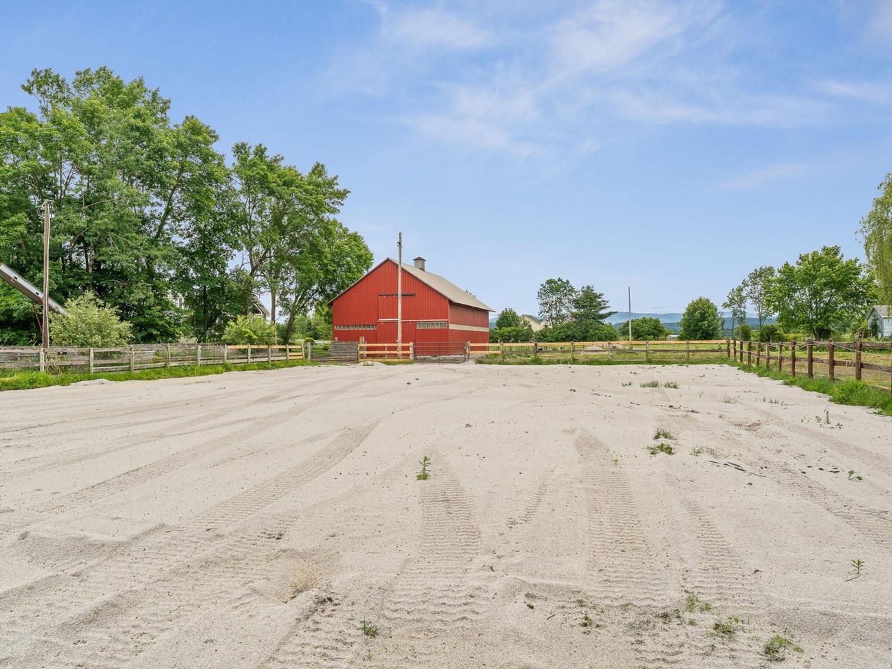 Riding arena behind barn