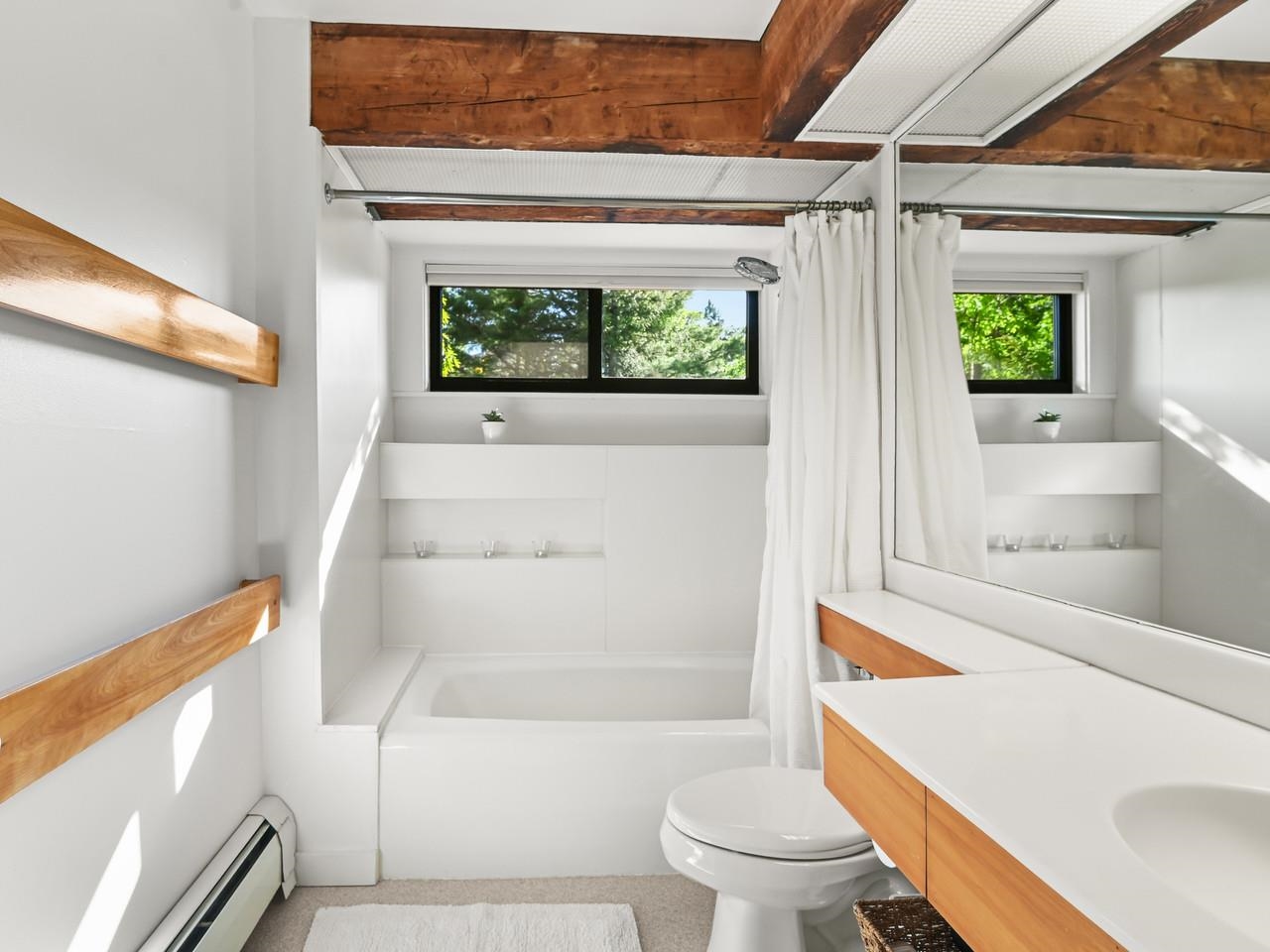 Bath with wood beam accents