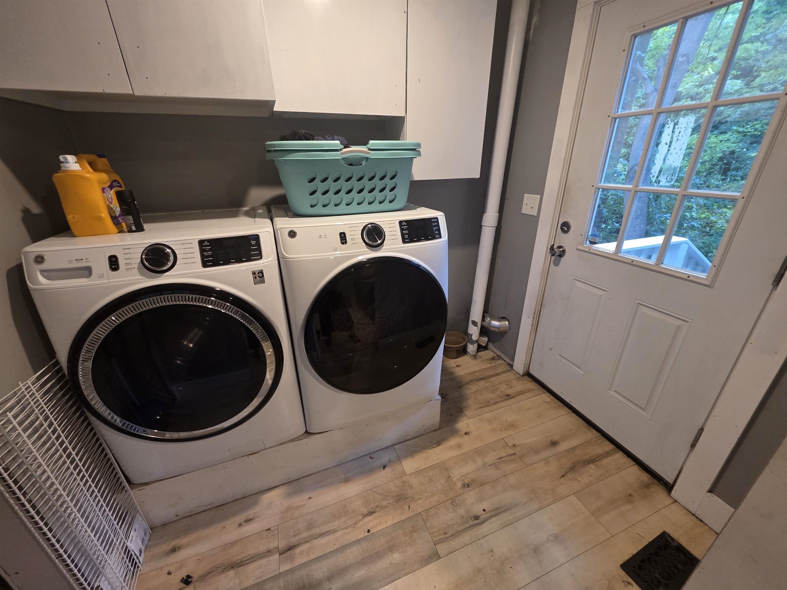 1st floor laundry and exit to covered back porch overlooking the brook