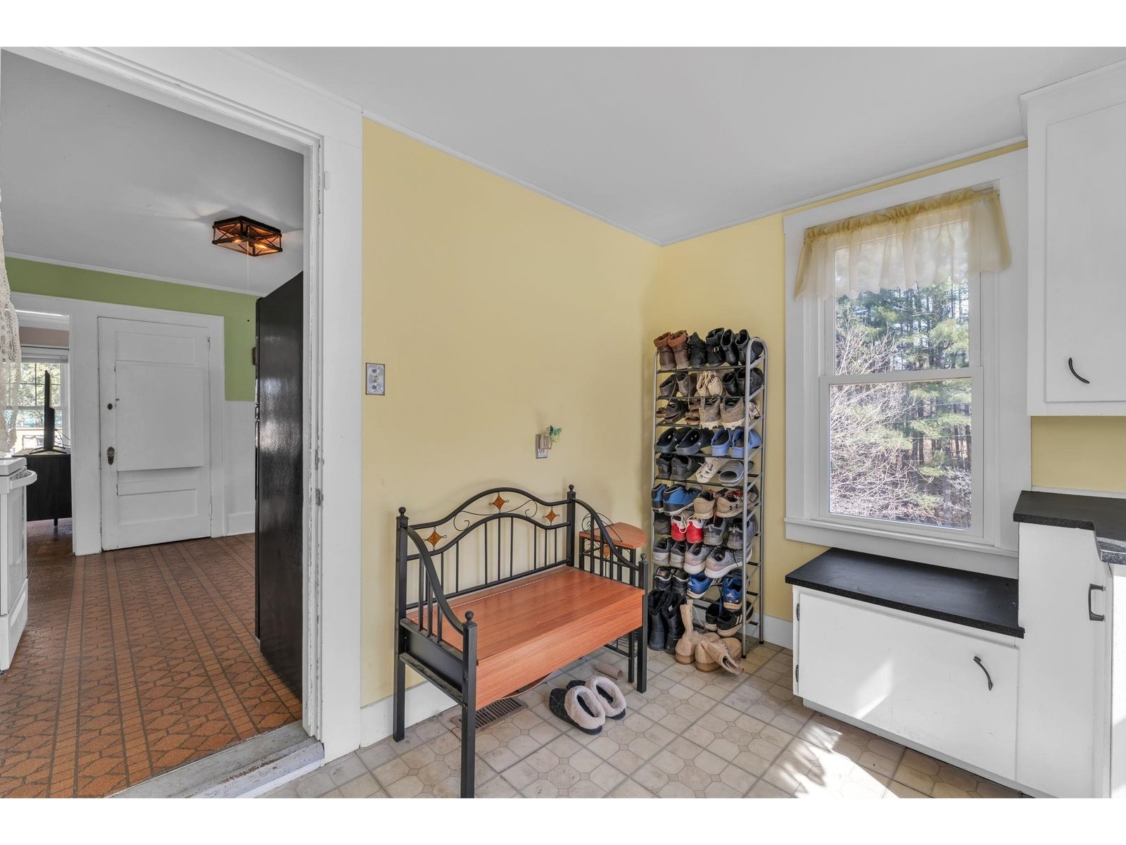 Oversized mudroom/enclosed porch with enough space for all your needs