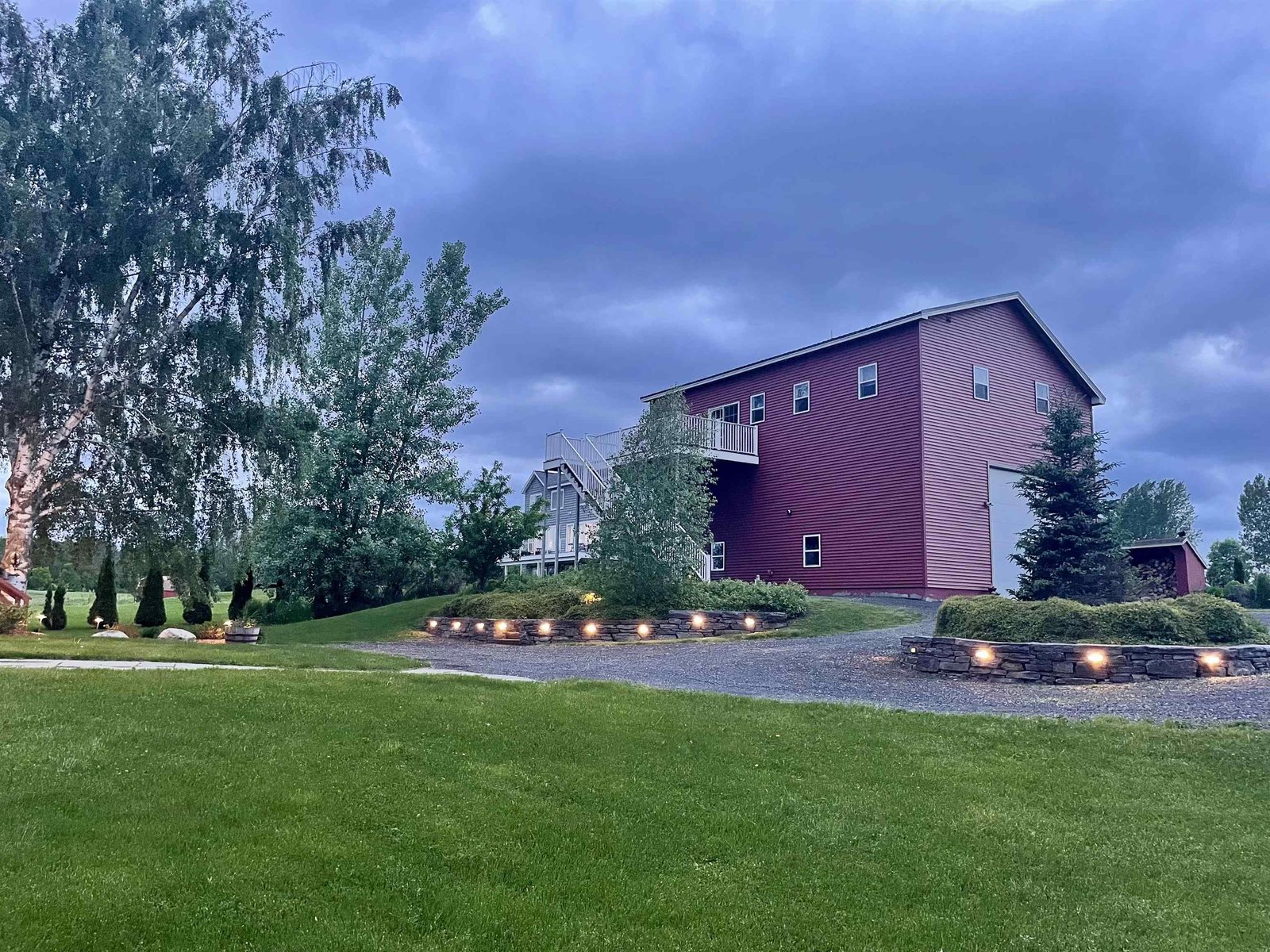 Recently completed stone landscape walls with lighting at dusk