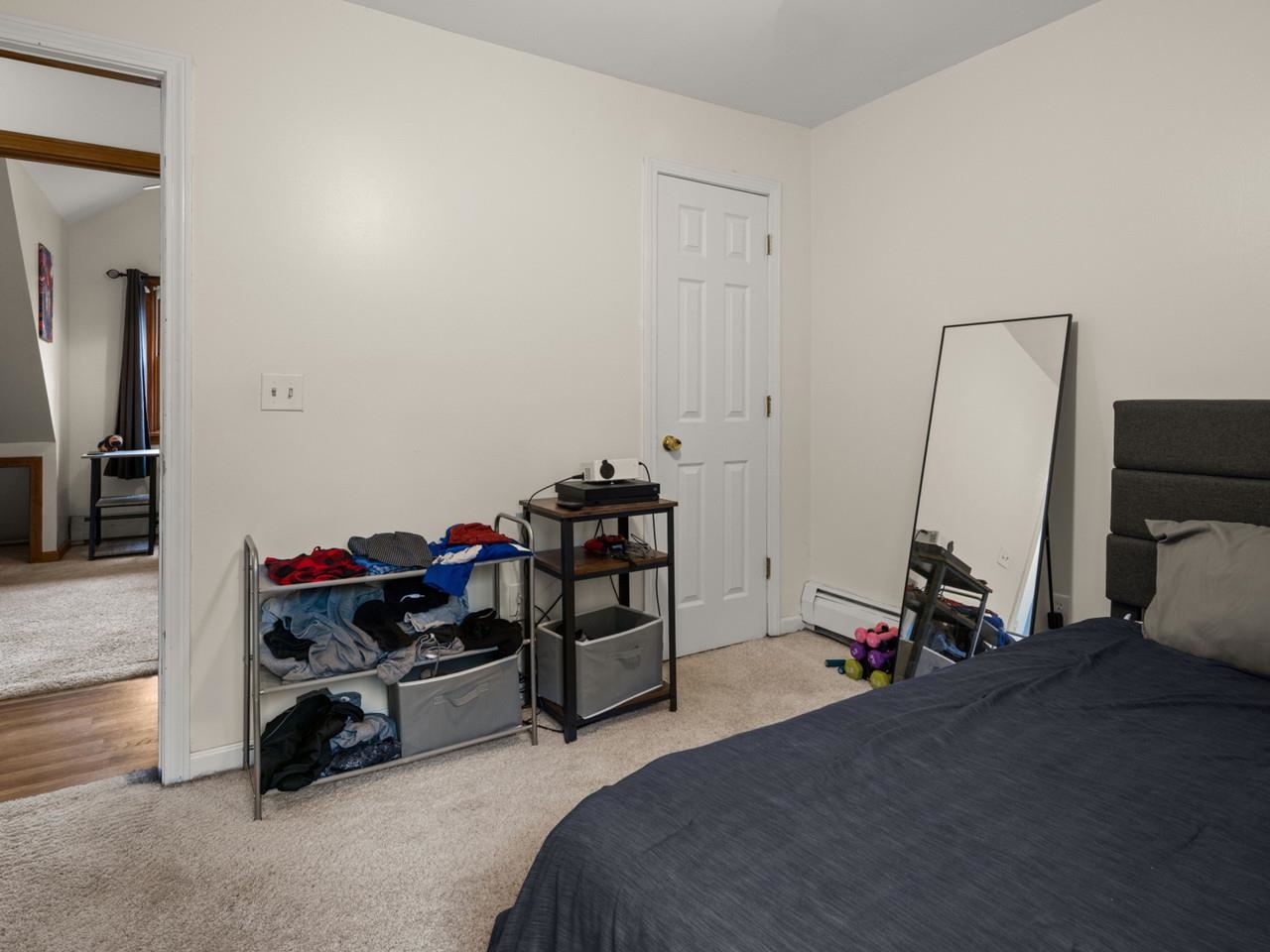 Carpeted bedroom with closet