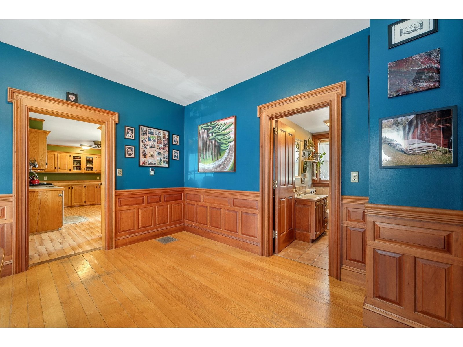 Hardwood raised paneling throughout dining room and living room