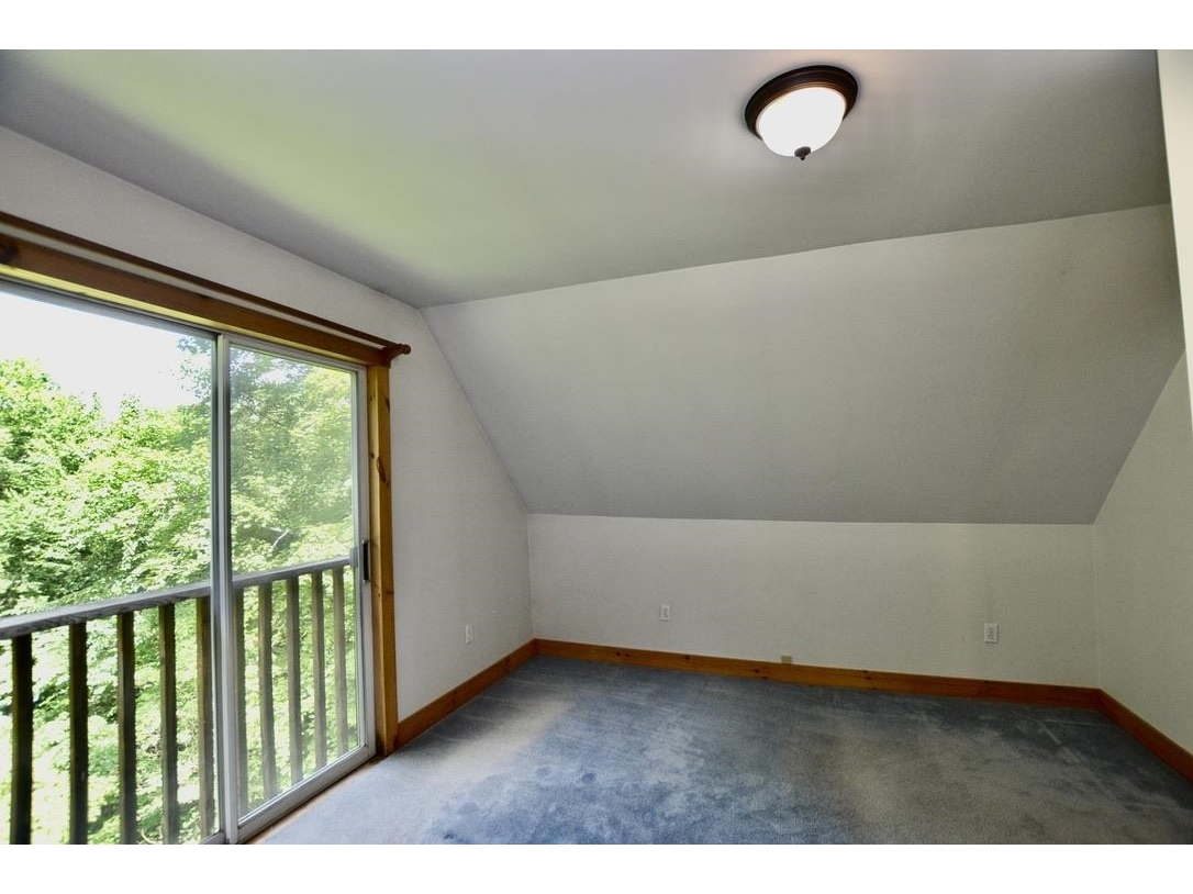 Large windows in second floor bedroom