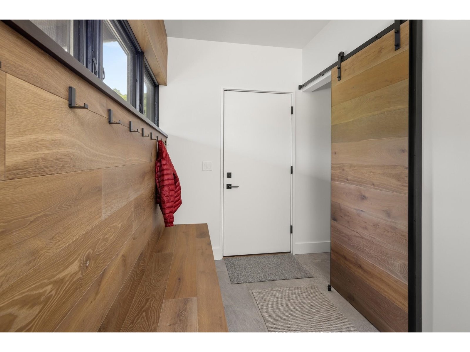 Mudroom with barn door for coat closet