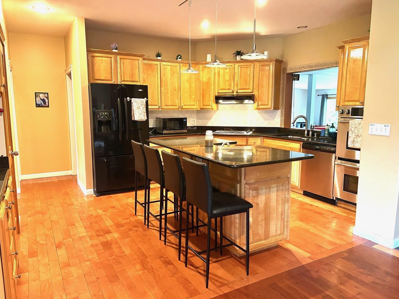Kitchen w/ granite countertops, double oven & gas stove.