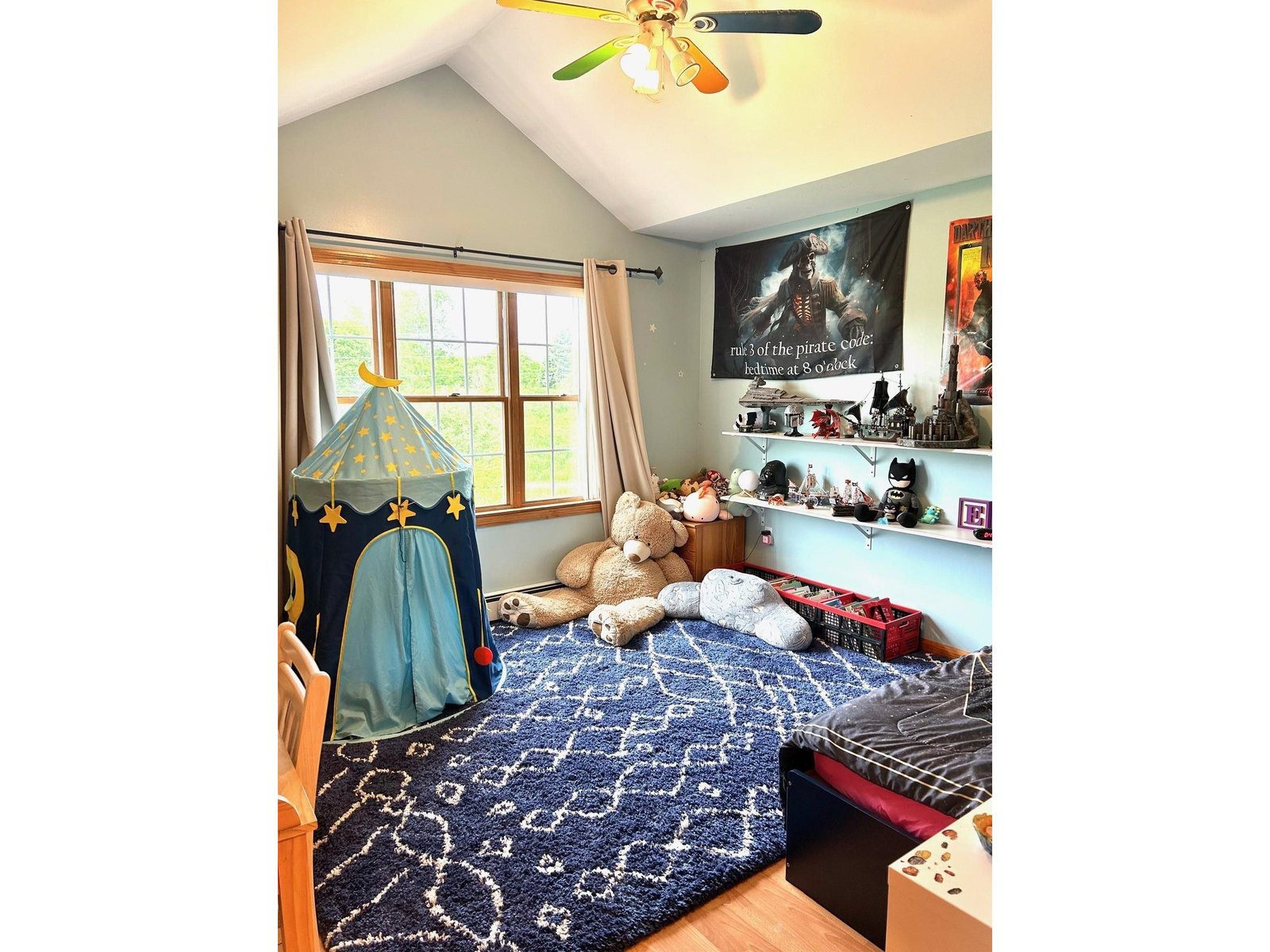 Bedroom w/ cathedral ceilings.