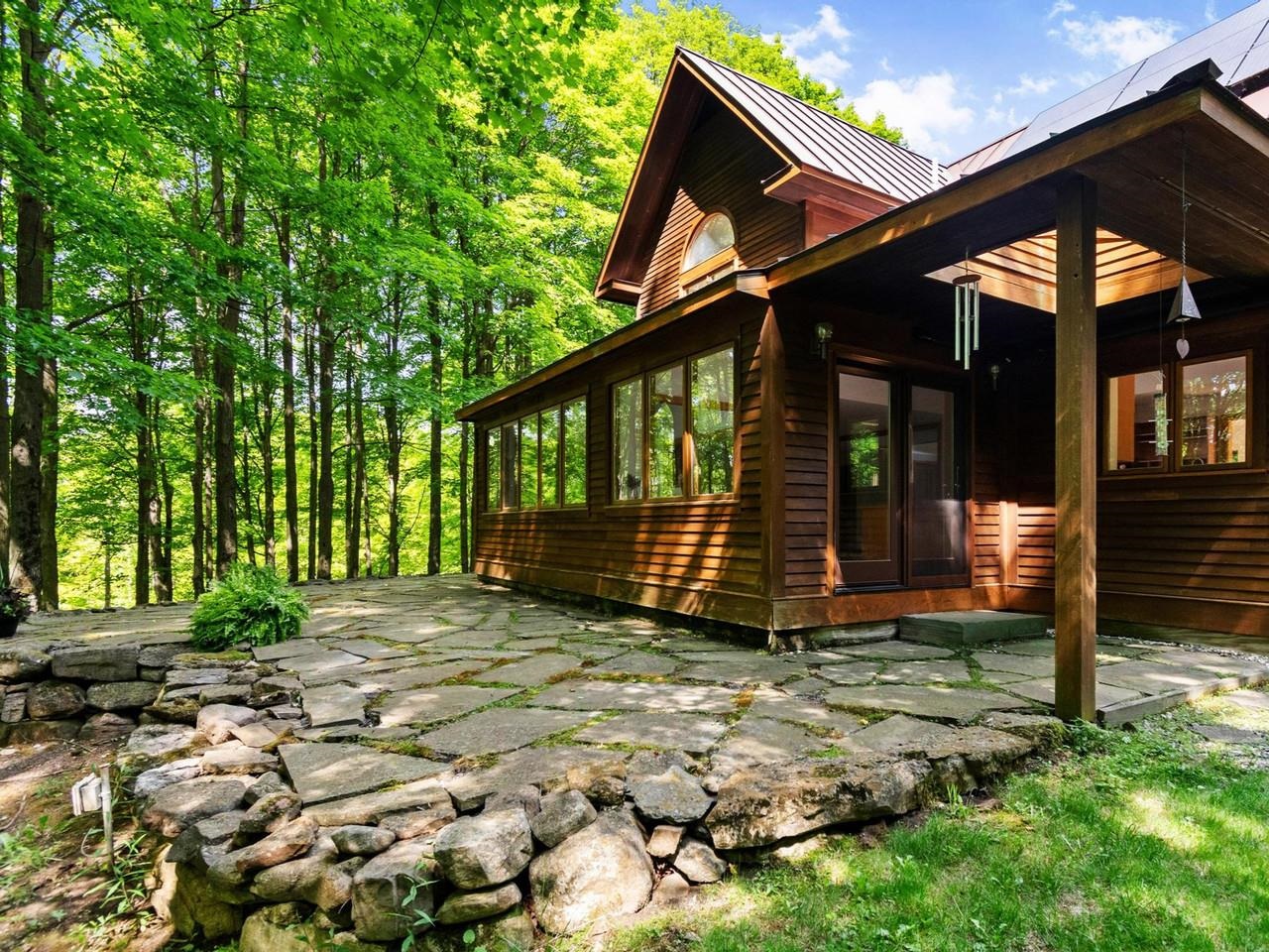 Stone patio & sunroom in back
