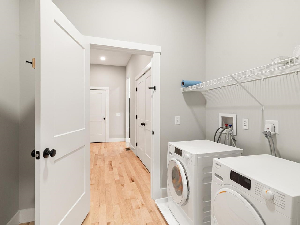 Laundry room with wood floor