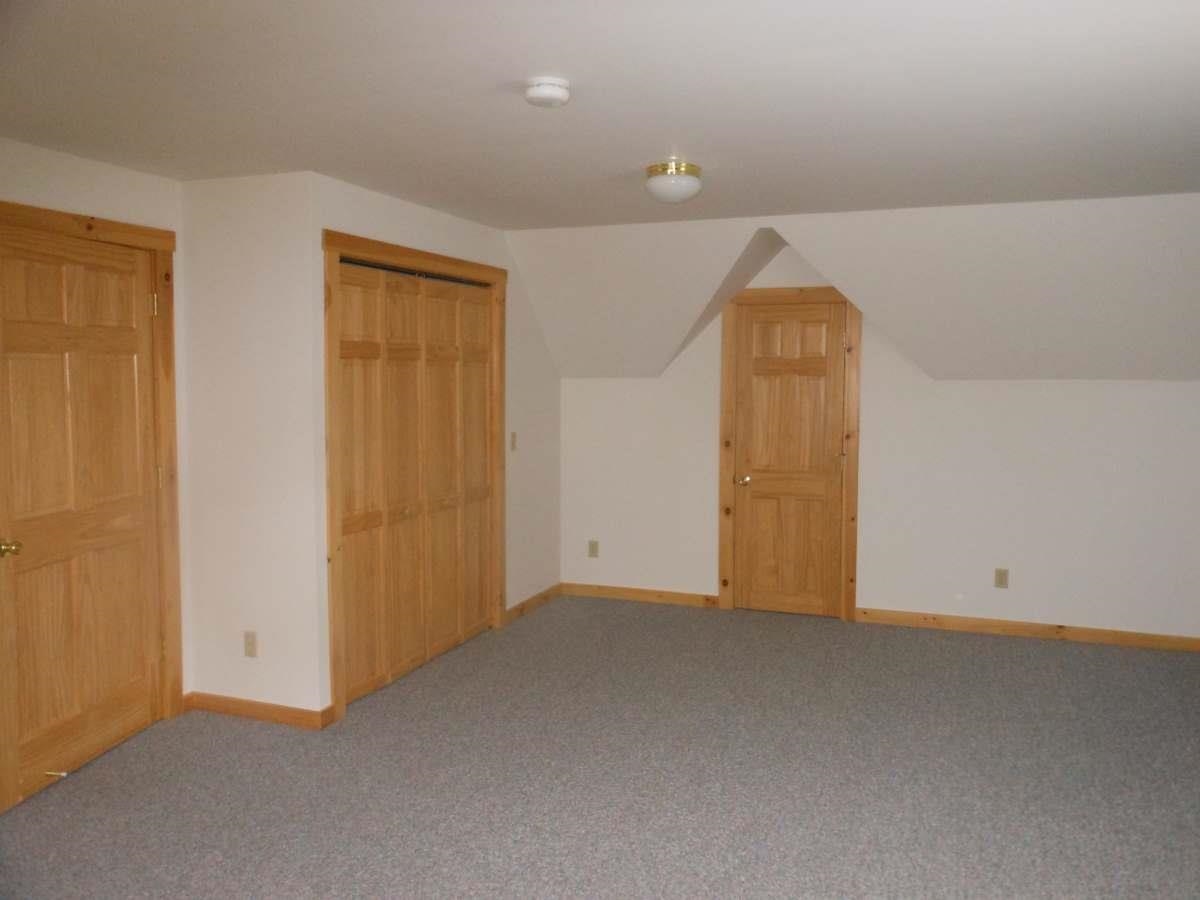 down bedroom with walk in closet