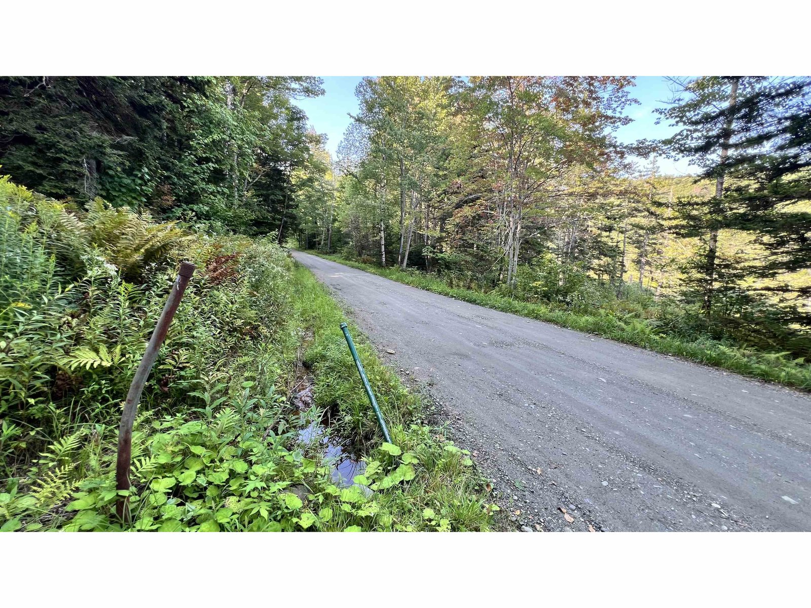 facing S: culverts for run-off direct to pond across road