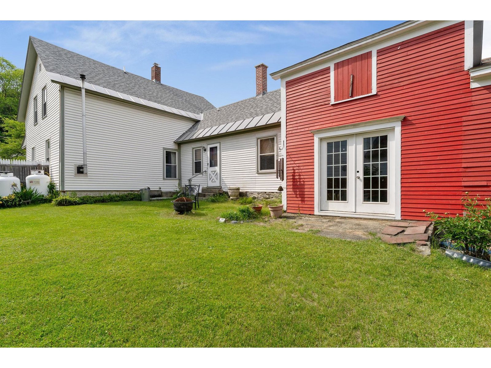 Spacious landscaped yard with entry to both house and attached barn