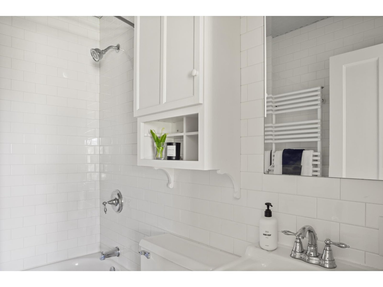 Ensuite bathroom to bedroom with queen bed and den/officehouse