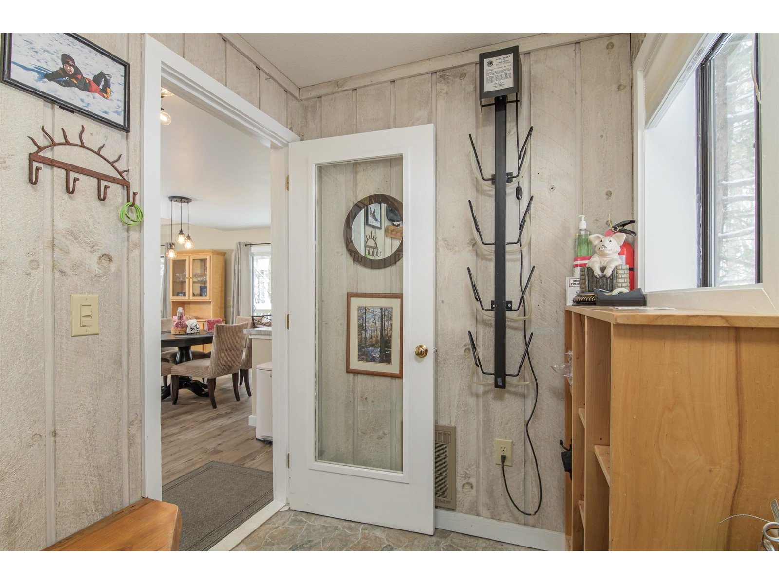 Mudroom with built ins and boot dryer leading to 2 private ski closets