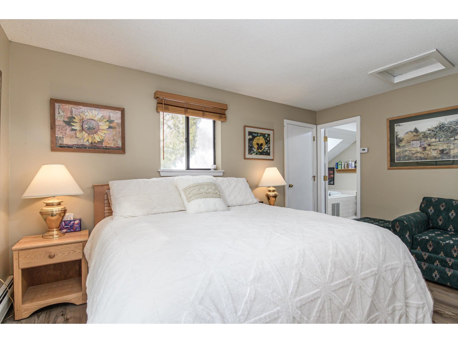 Primary suite with privacy balcony overlooking wooded setting