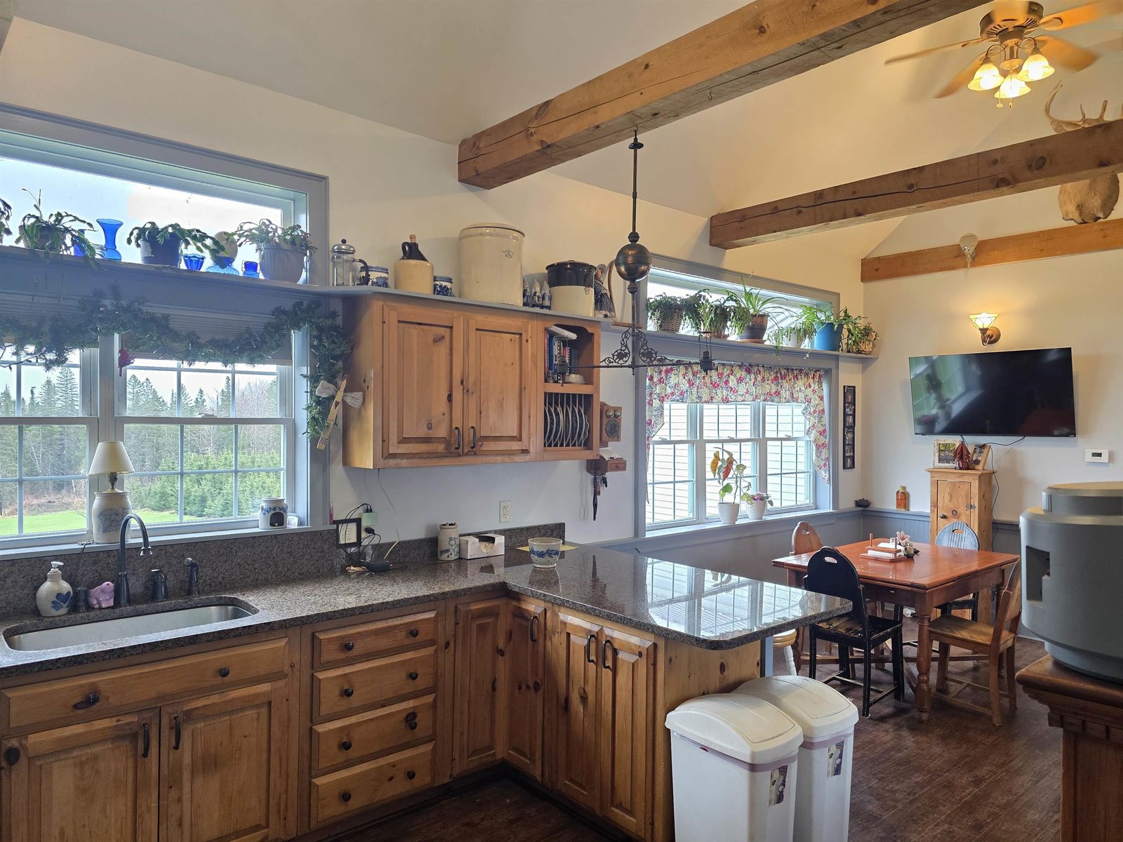 Big open eat in kitchen with vaulted ceilings and cross beams
