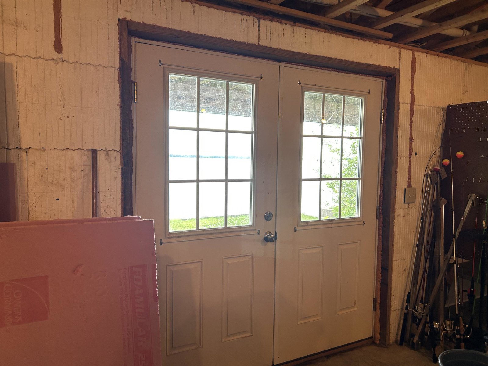 Double doors in storage area on lower level.