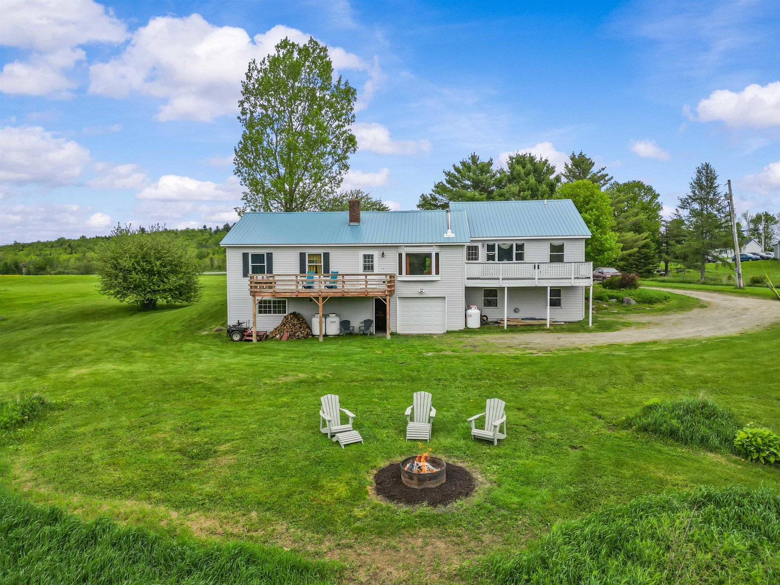 Aerial photo shows the firepit and back of the home/ apartment.