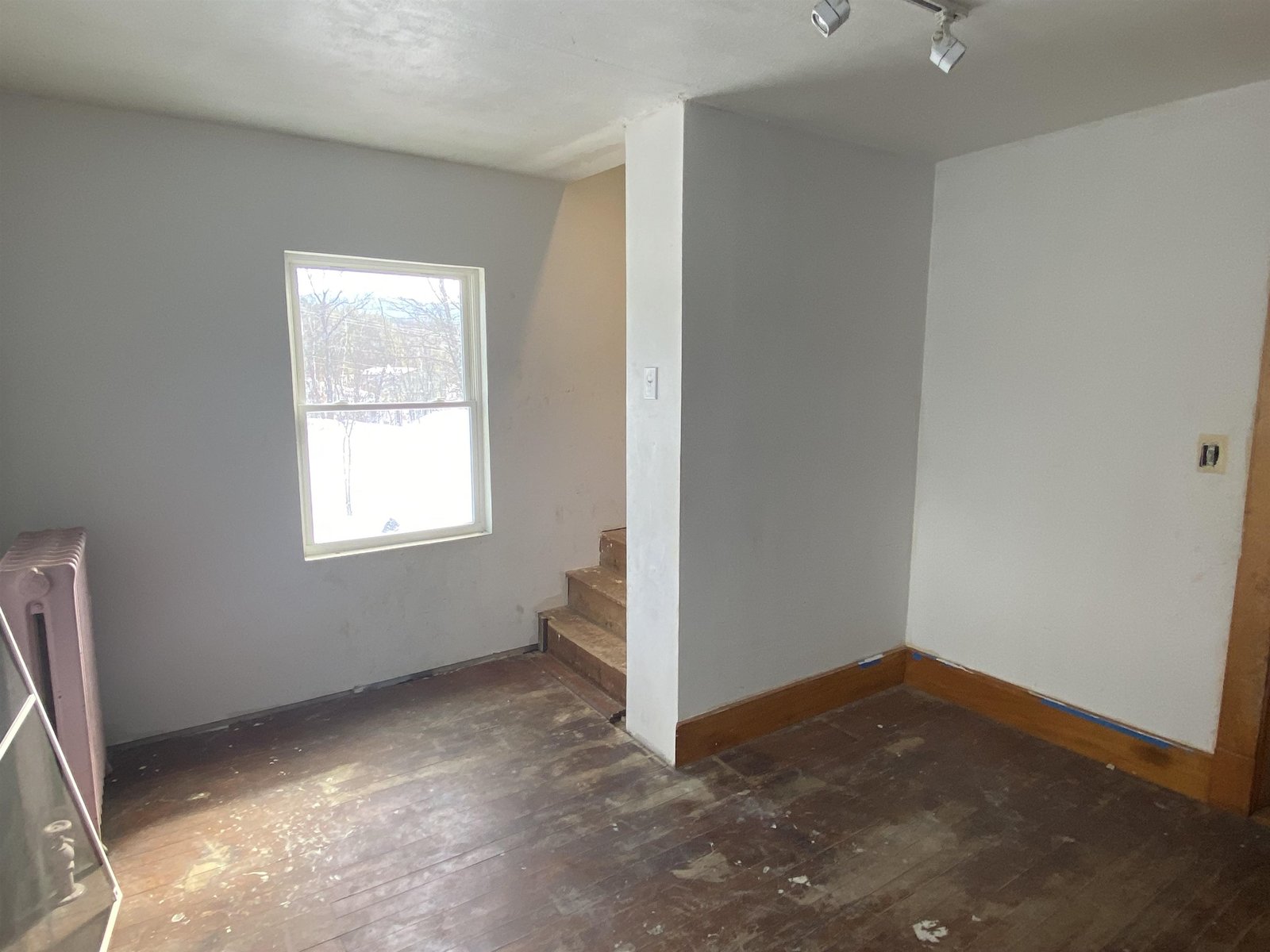 2nd floor bedroom with staircase to attic