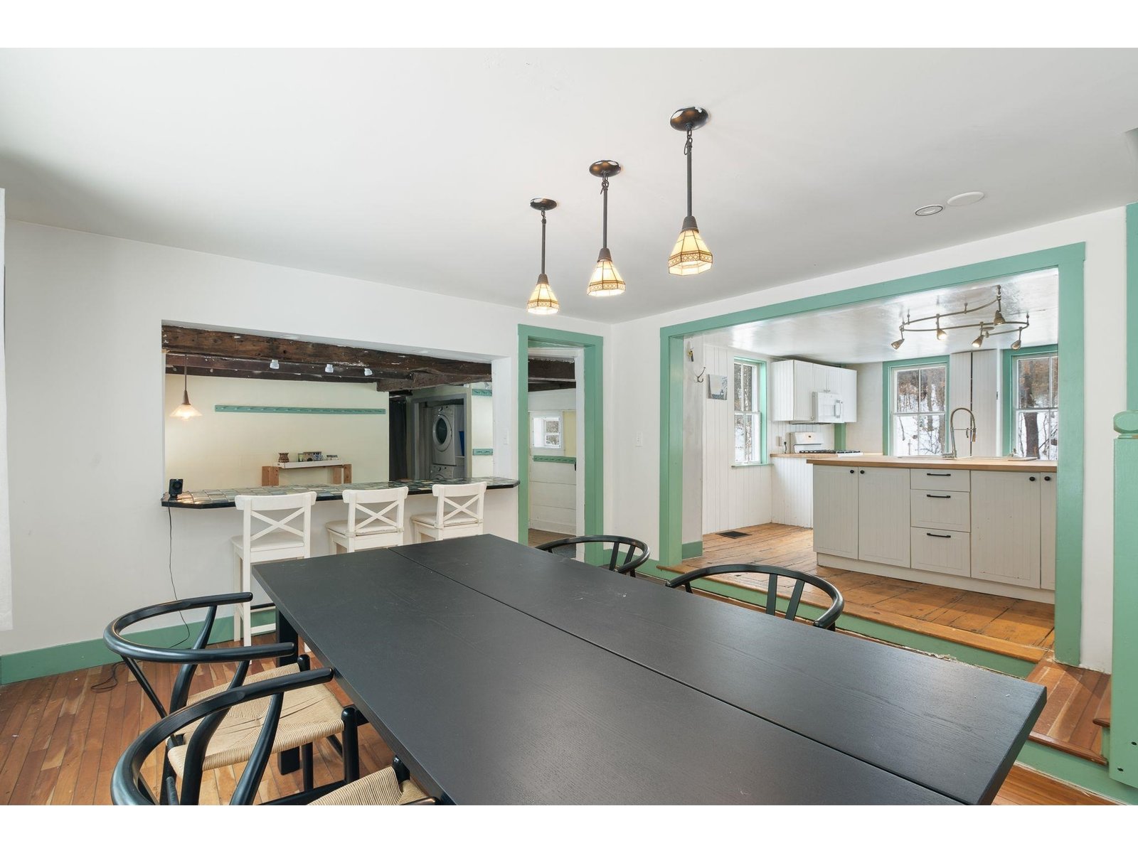 Dining view of kitchen, mudroom w/ washer & dryer.