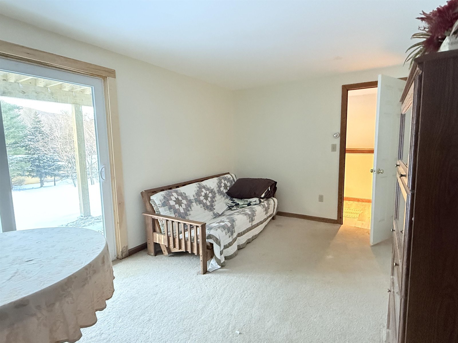 Lower level family room with slider out and door to the mucroom