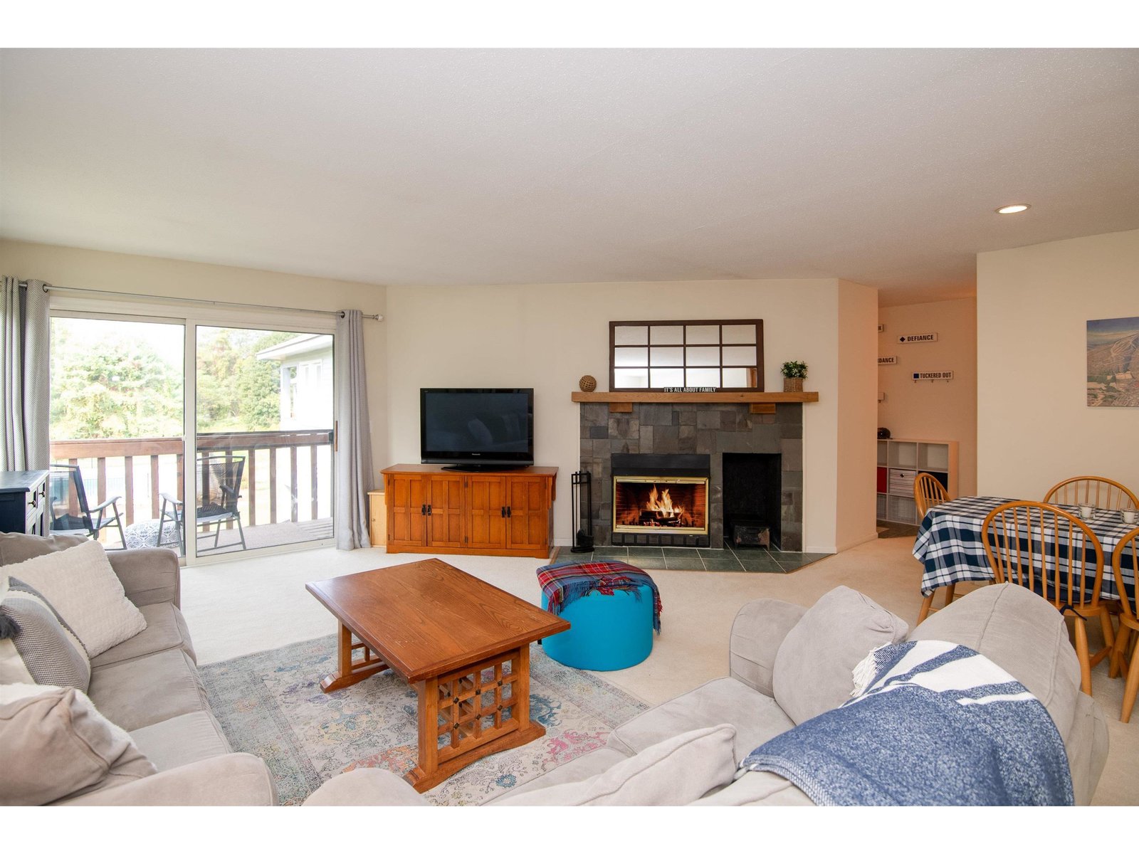 Open living space centered by woodburning fireplace