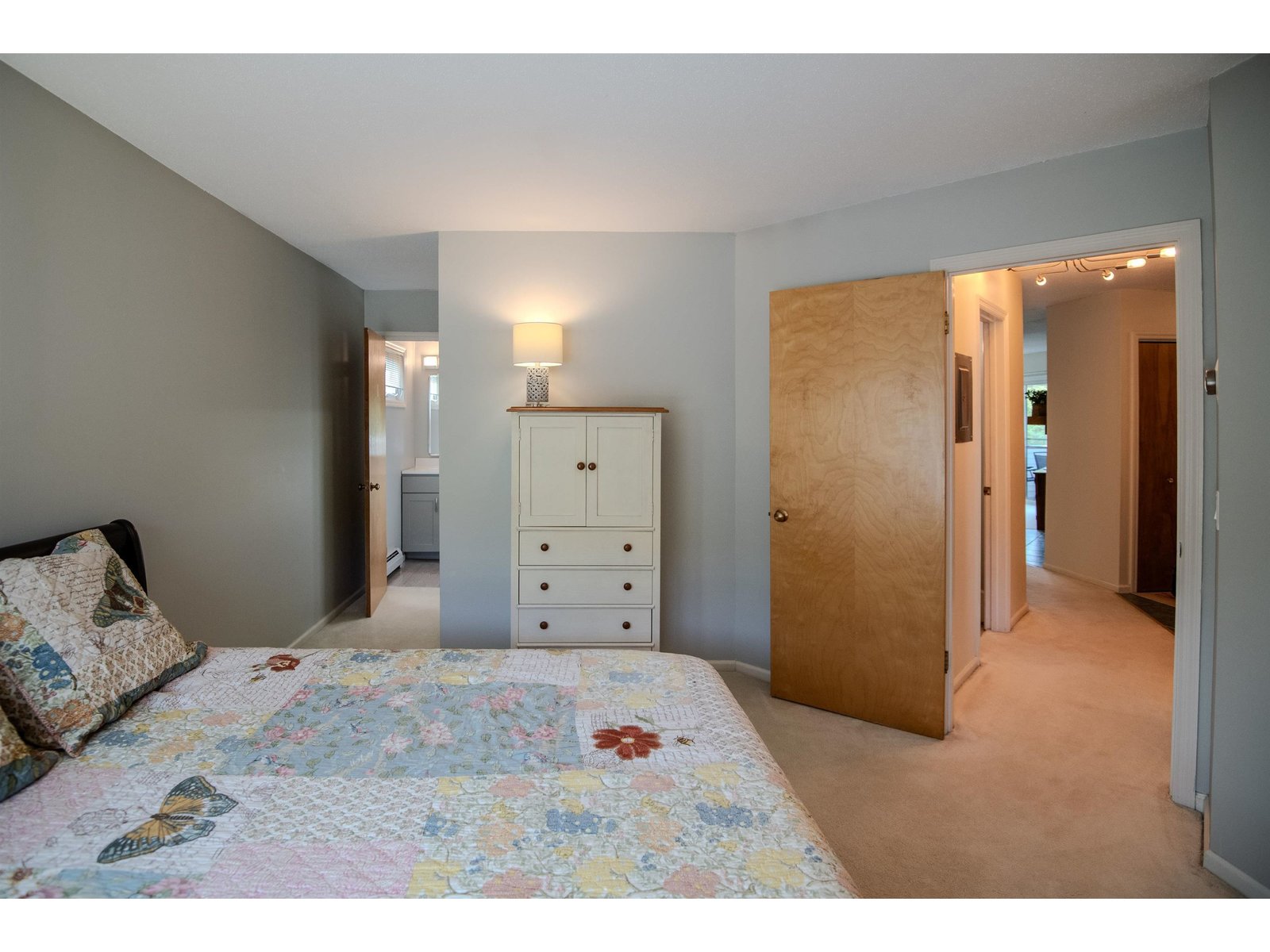 Private primary bedroom suite with walk in closet