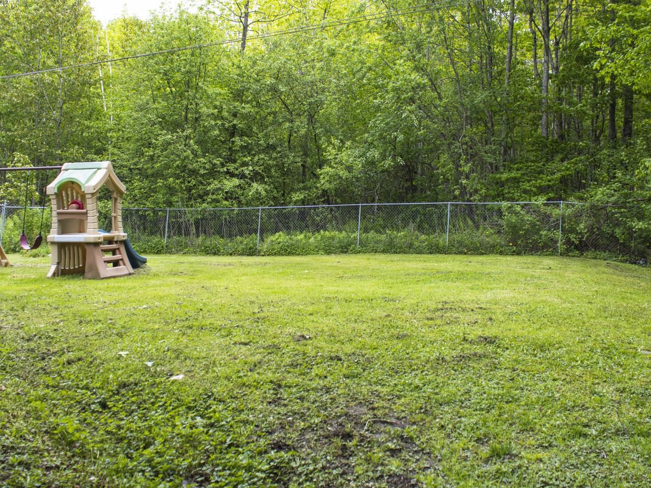 Fenced yard with wooded view