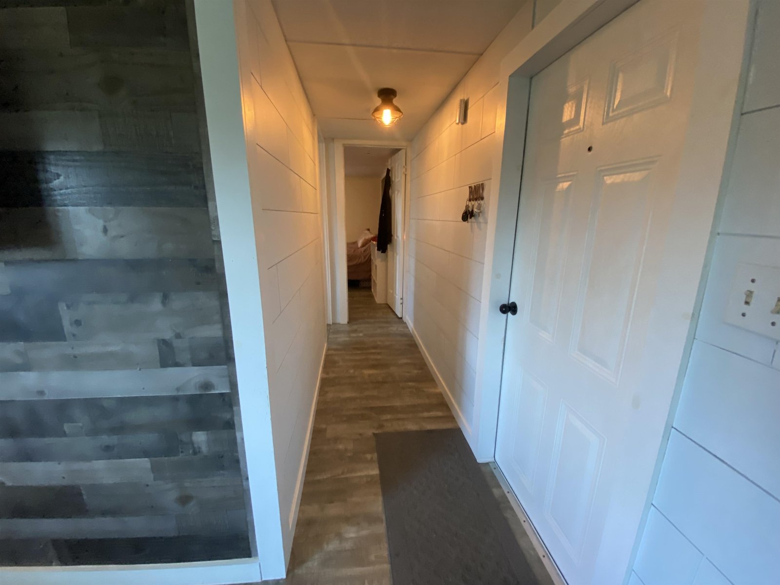 Hallway to 2 bedrooms and half bath