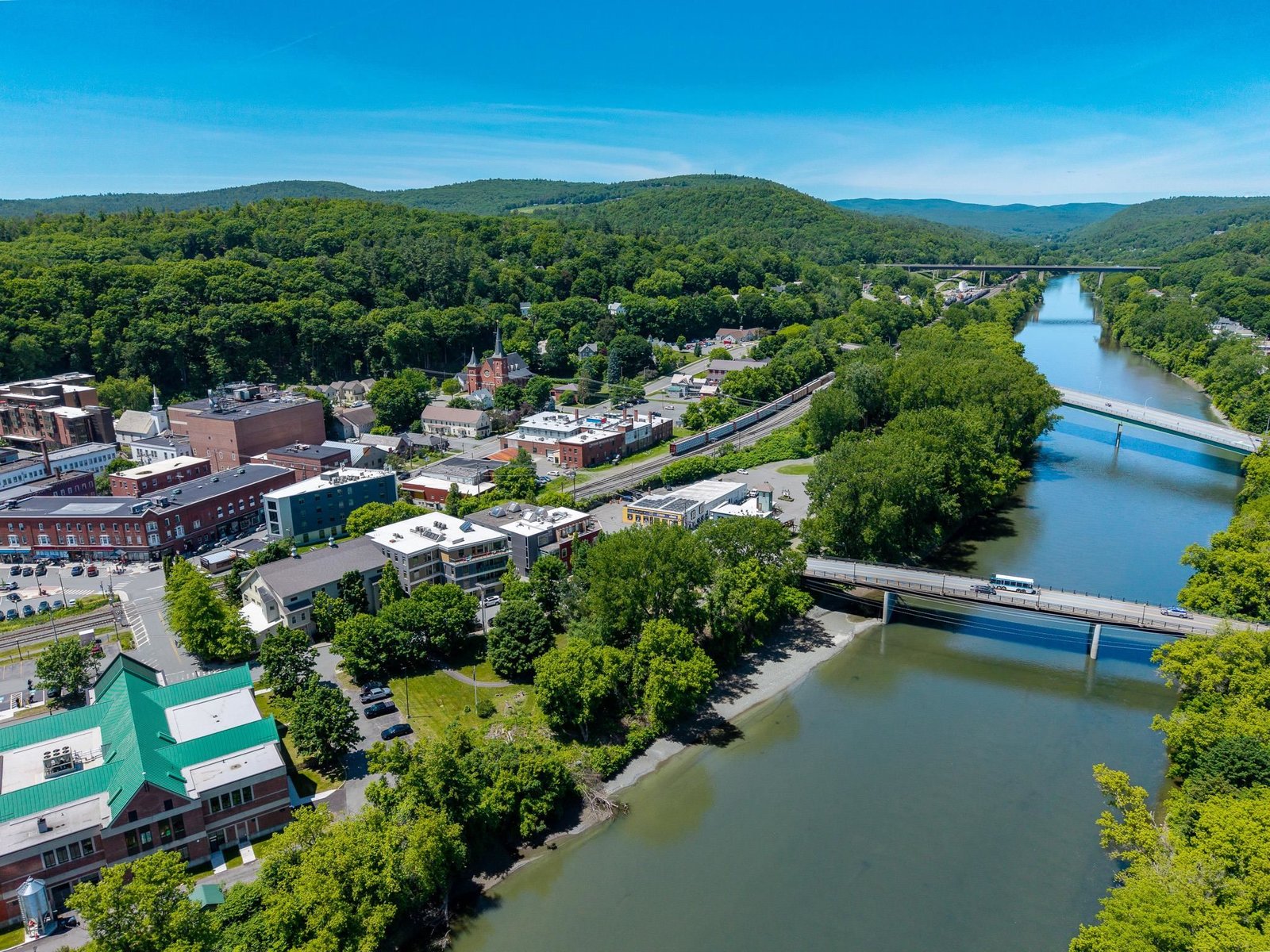 Aerial shot of the building and park that sits on the river