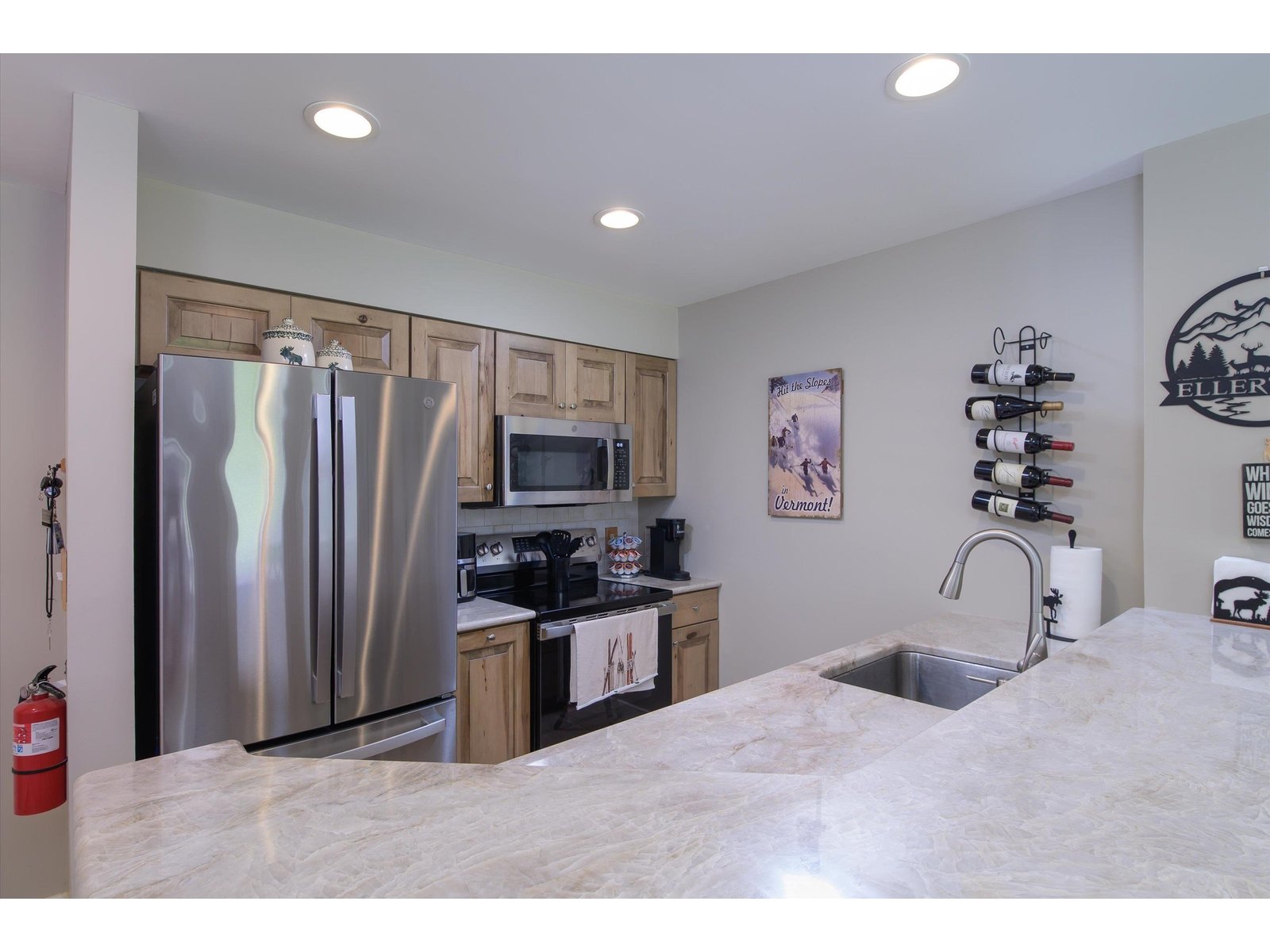 Remodeled kitchen with wood cabinetry and tile floors