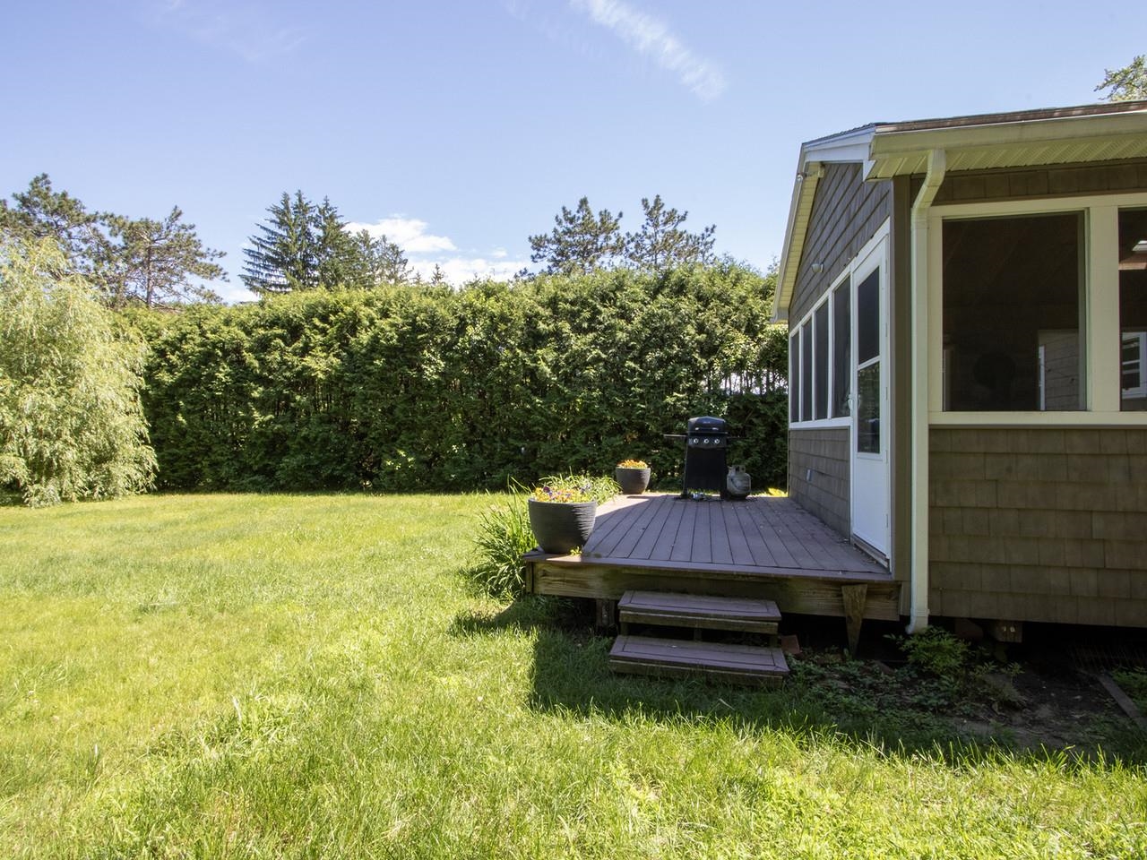 Screened porch leads to deck