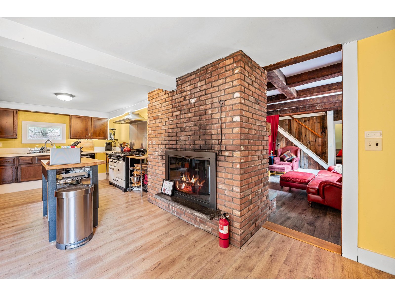 Kitchen with double sided brick hearth fireplace