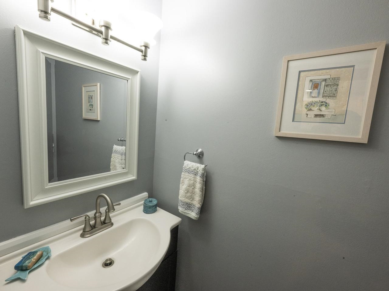 Tucked 1/2 bath near entry