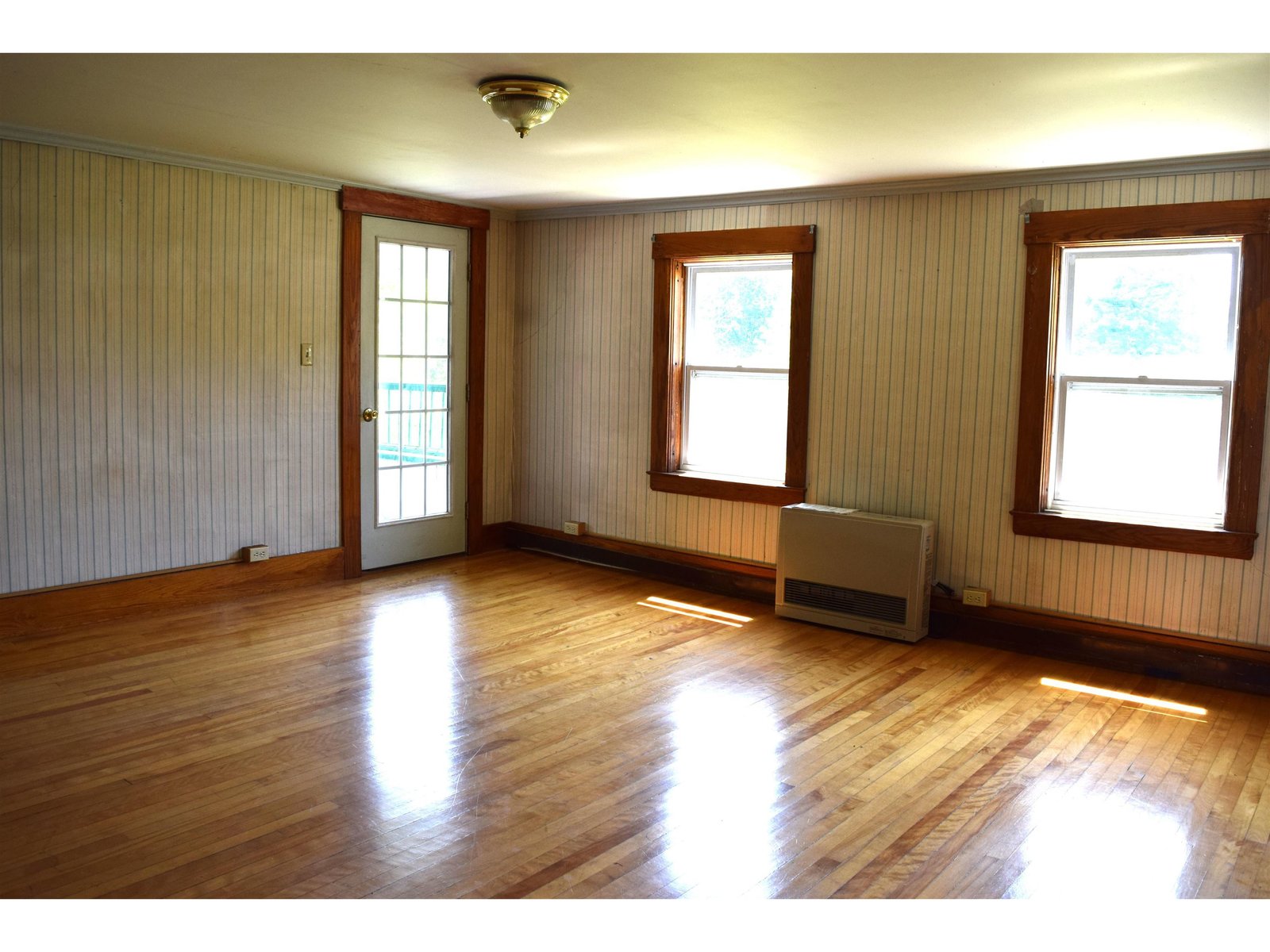 Living room with Hardwood floors propane monitor heat