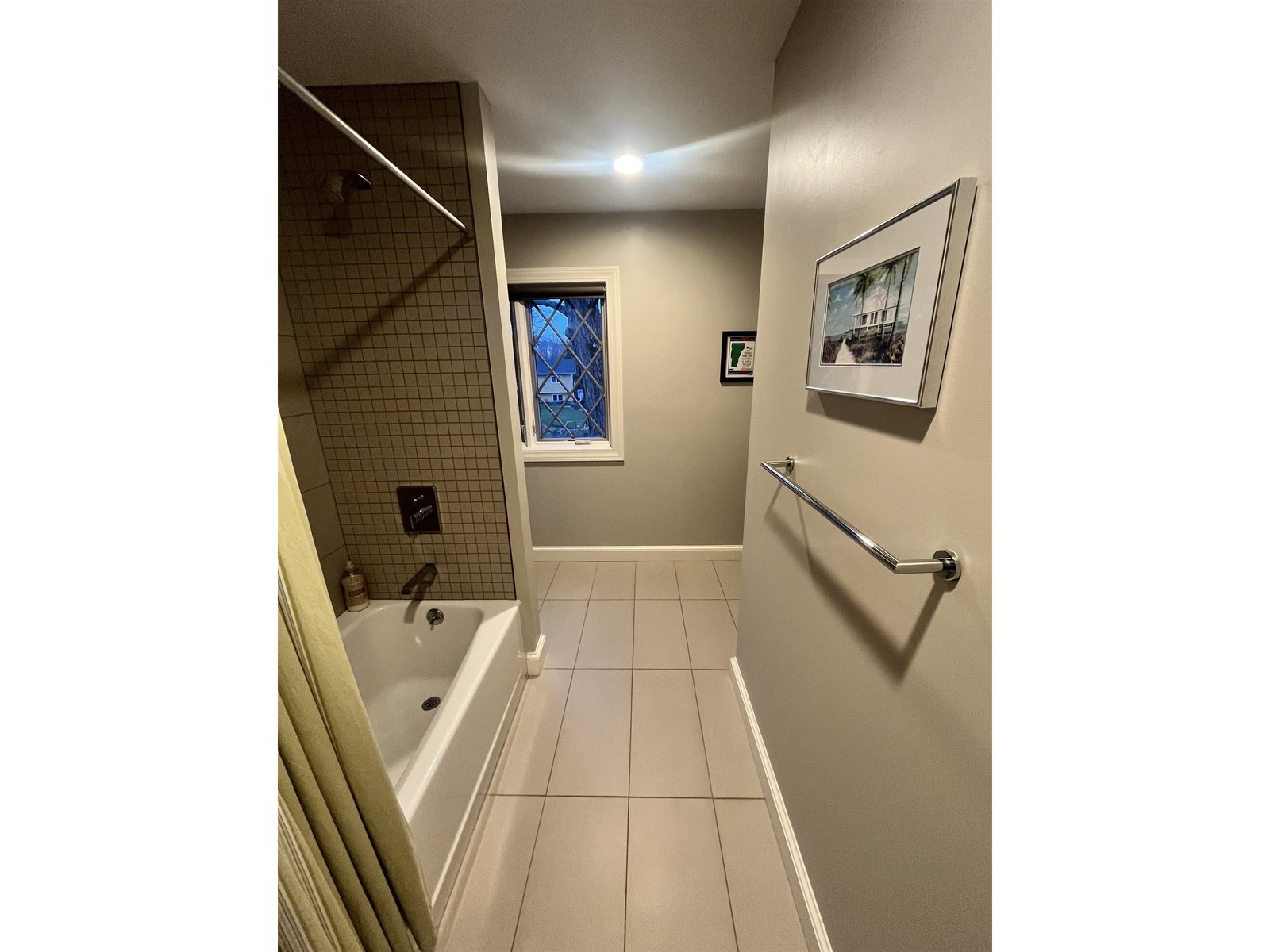 Hall bath which connects to 2nd ensuite bedroom with high mounted shower head