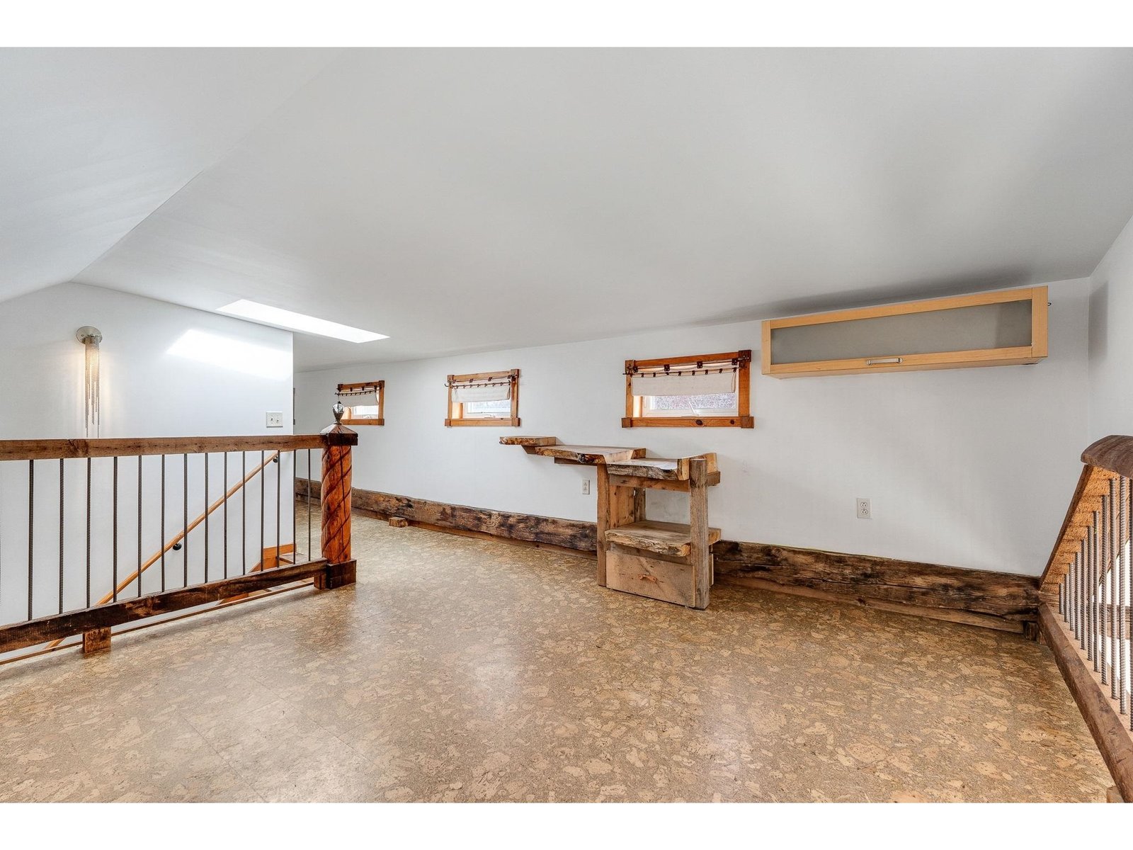 Landscape windows along with skylights wall brighten upstairs area.