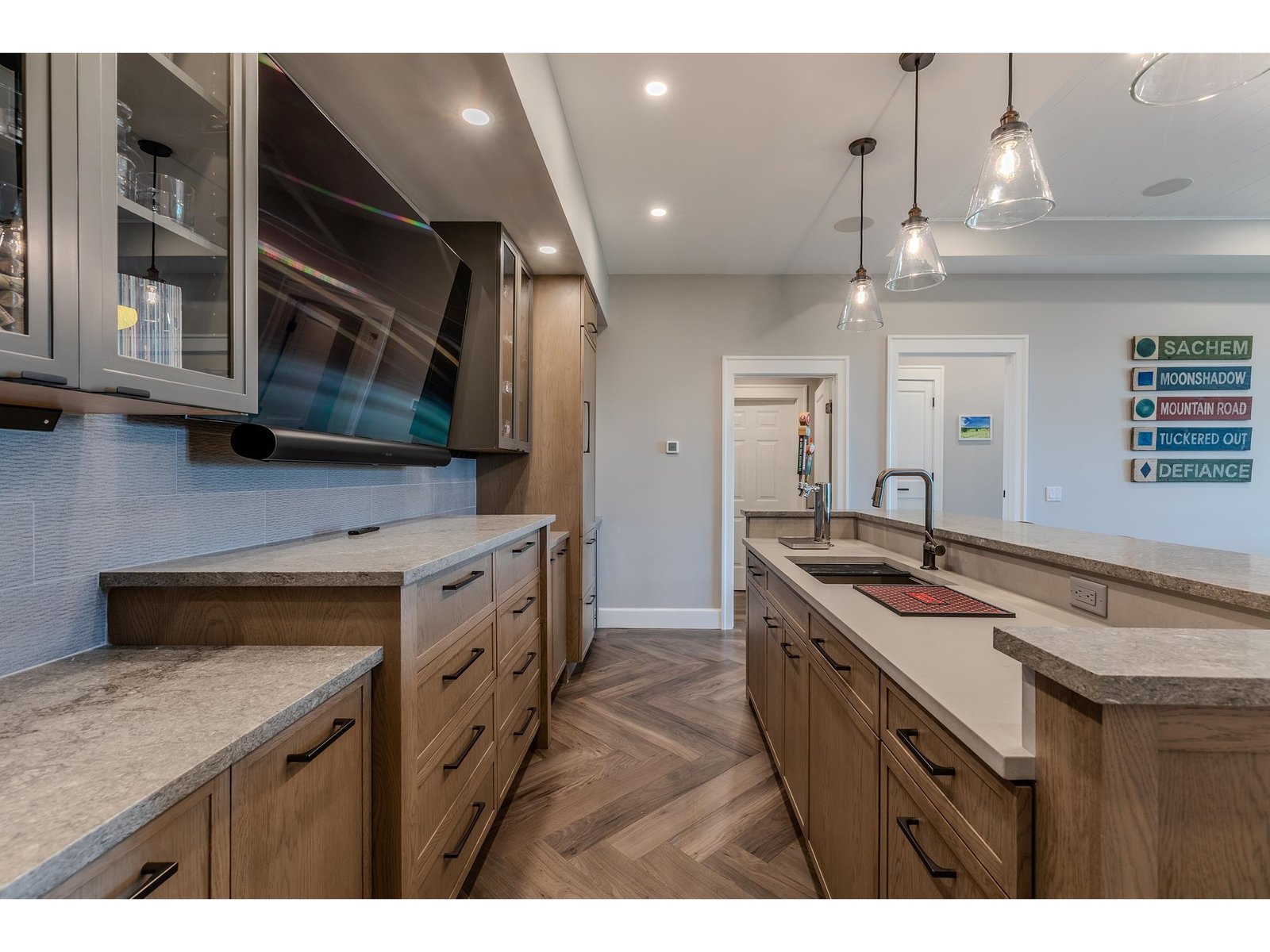 TV over bar, Subzero refrigerator, and dishwasher