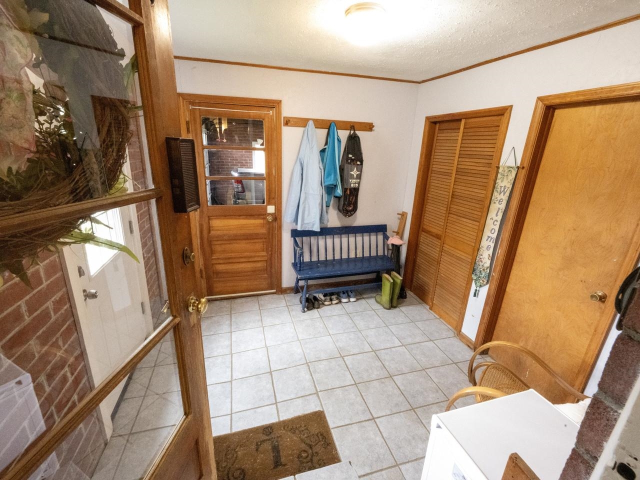 Tiled unheated mudroom