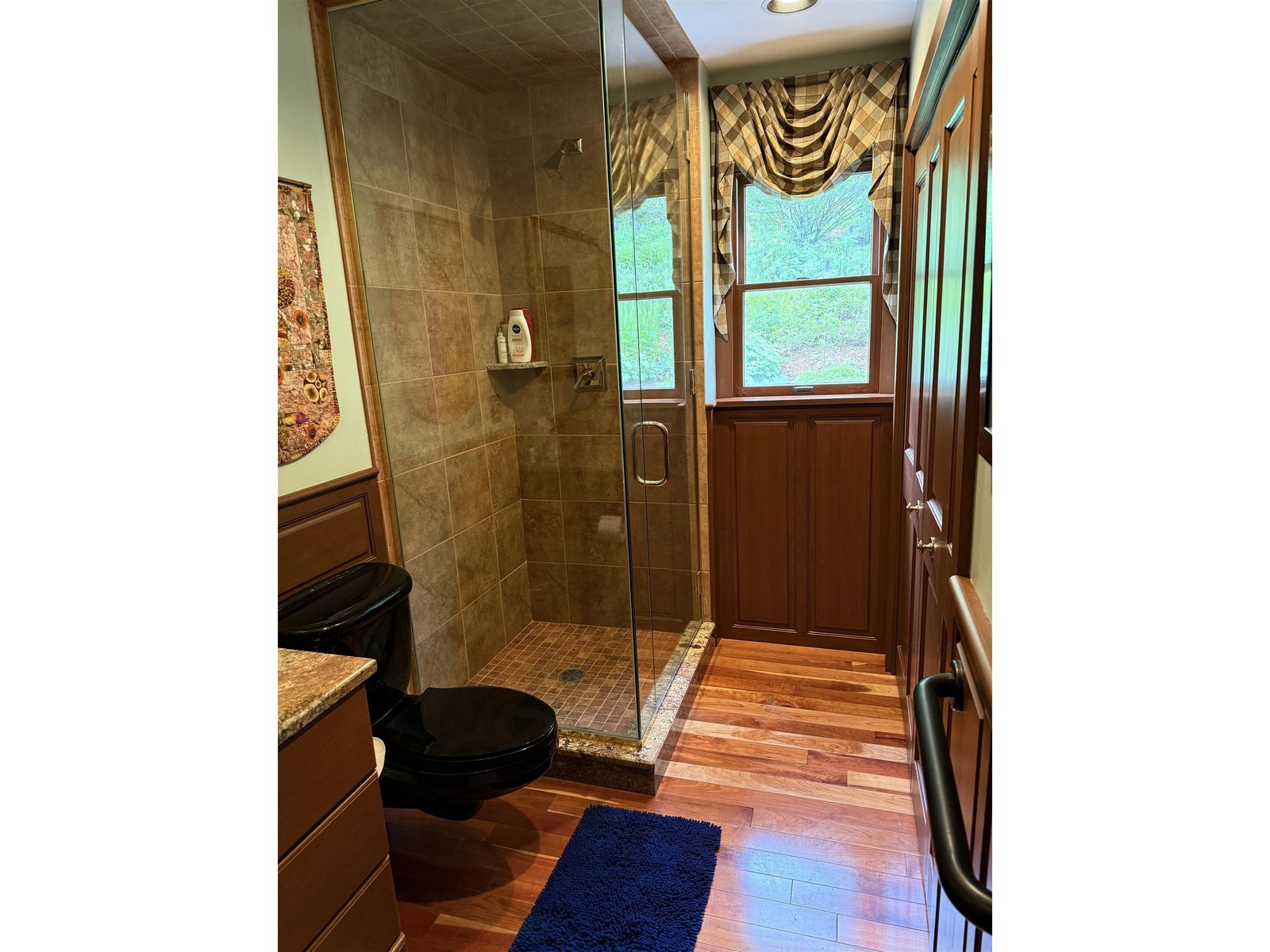 BATHROOM OFF LIVING ROOM HAS A RAIN SHOWER