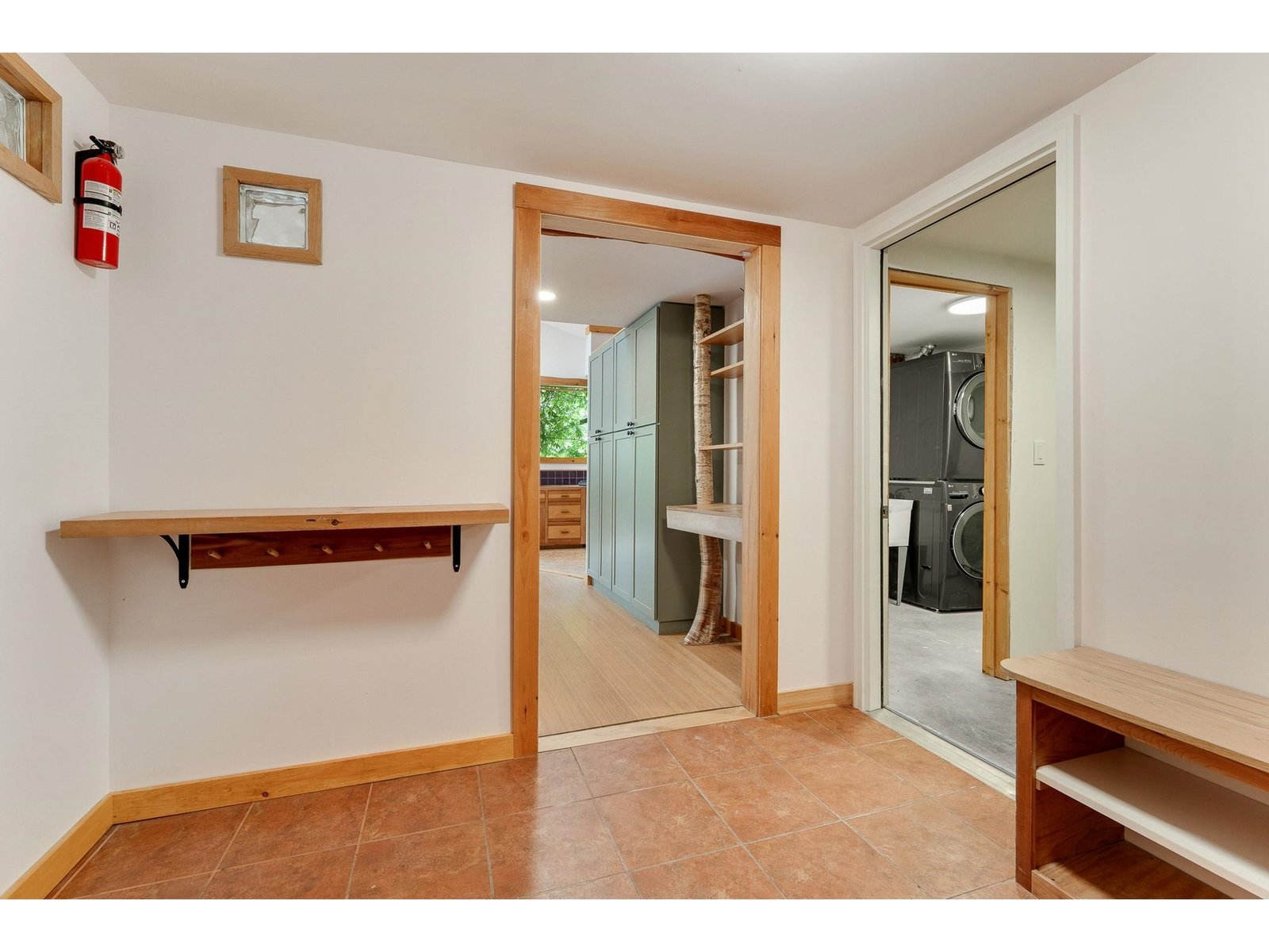 Left door leads to kitchen, right doors lead to laundry/systems room